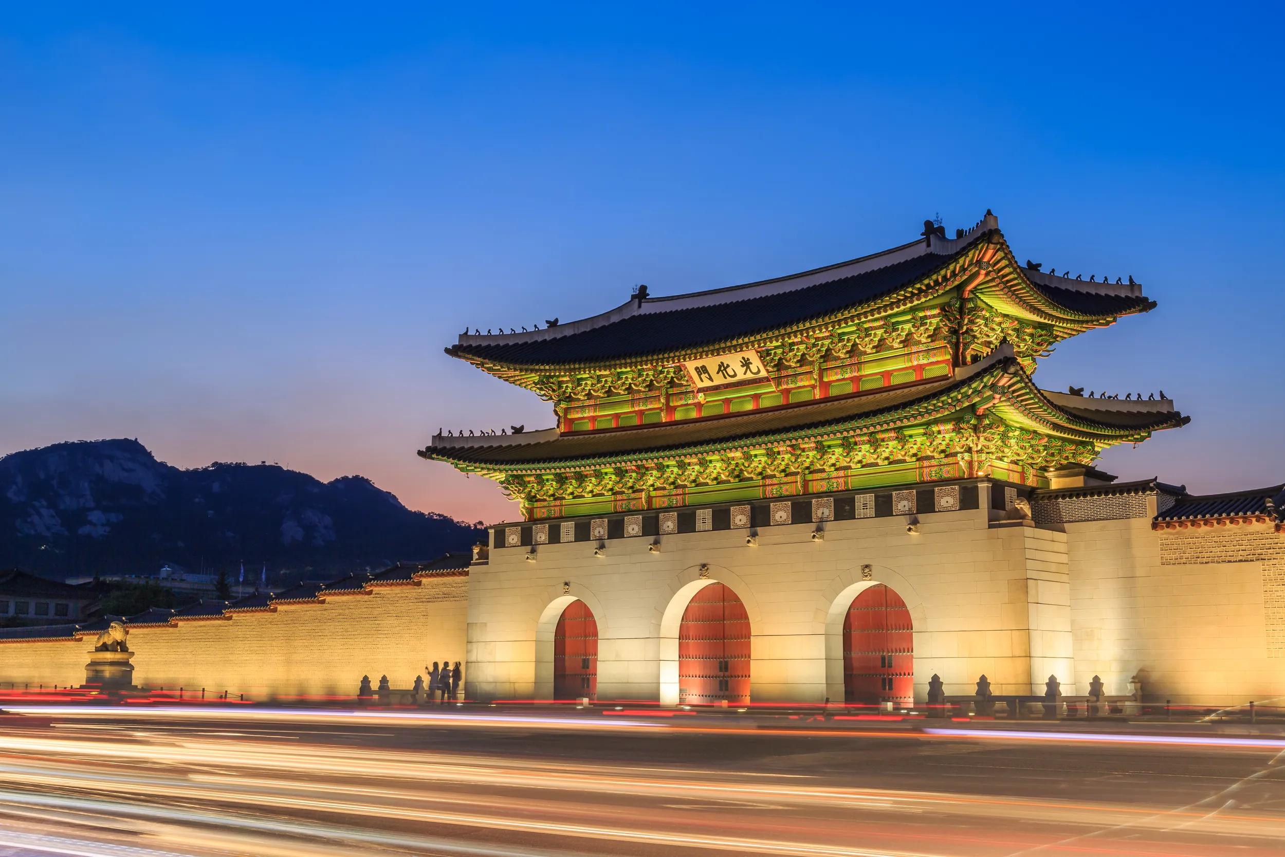 Close-up view of main gate of Gyeongbokgung Palace, Gwanghwamun with traffic trails at night, Seoul, South Korea.