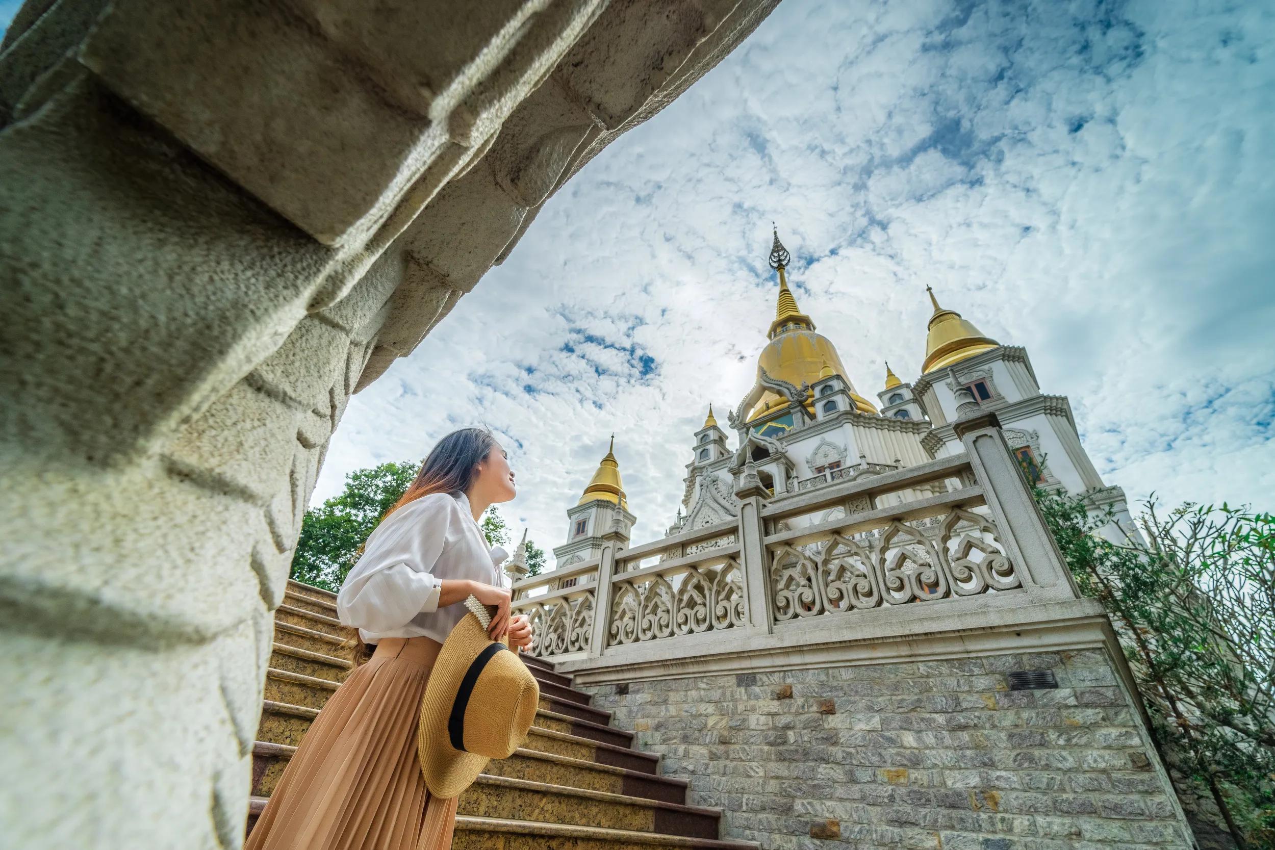 Asian woman walking outdoors in Buu Long Pagoda in Ho Chi Minh City. A beautiful buddhist temple hidden away in Ho Chi Minh City at Vietnam. 