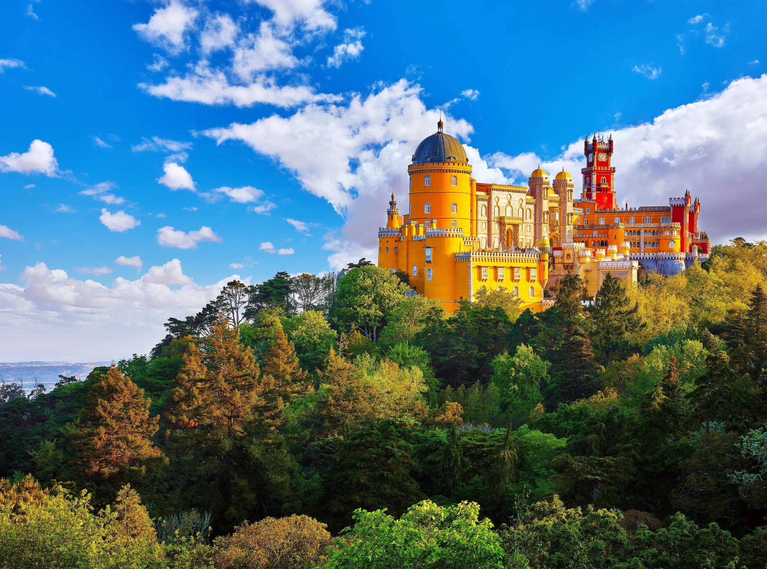 Palace of Pena in Sintra. Lisbon, Portugal. Famous landmark. Summer morning landscape with blue sky.