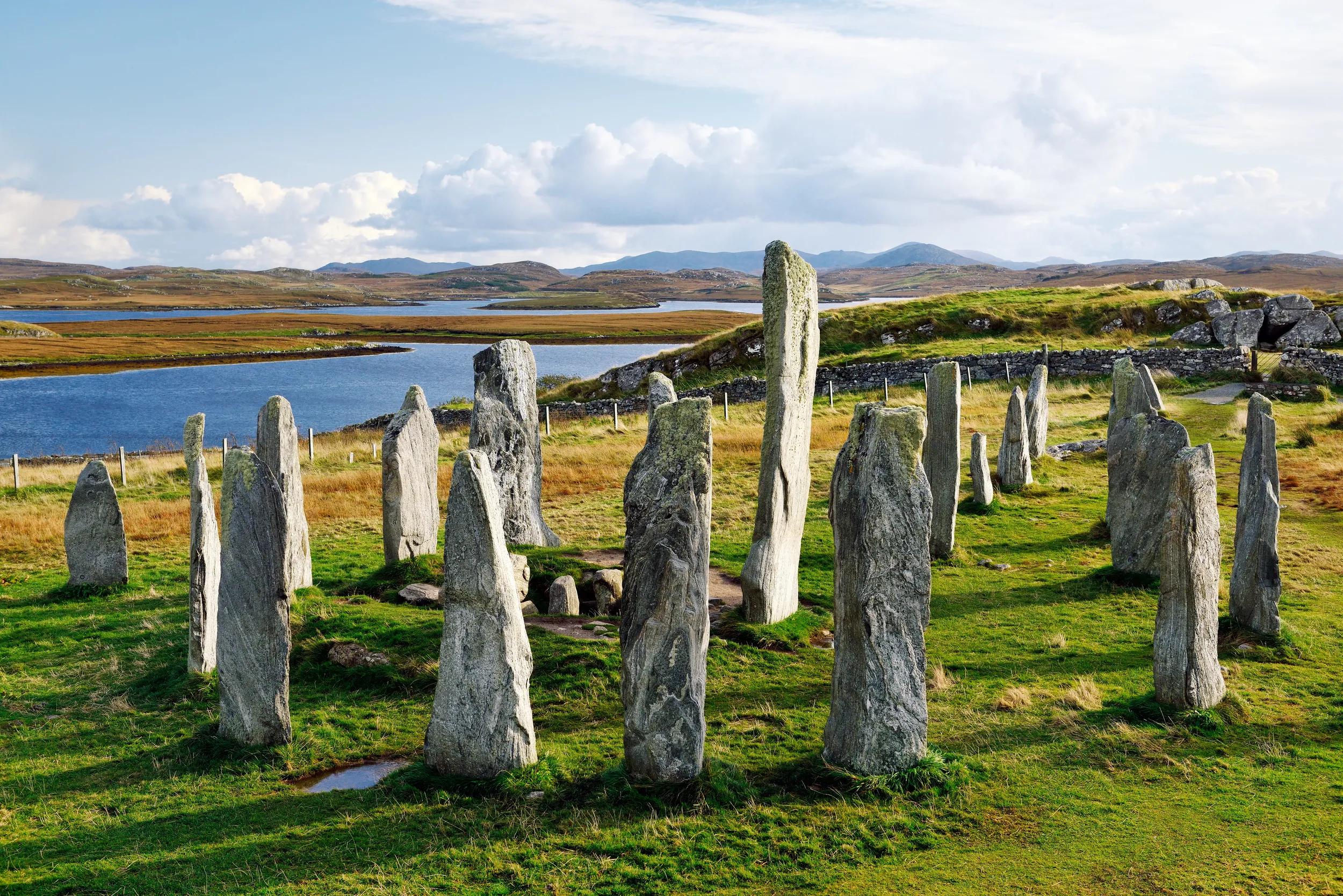Tursachan prehistoric stones at Callanish, isle of Lewis, Scotland. aka Callanish I. Centre monolith, circle stones and chambered tomb looking S. East