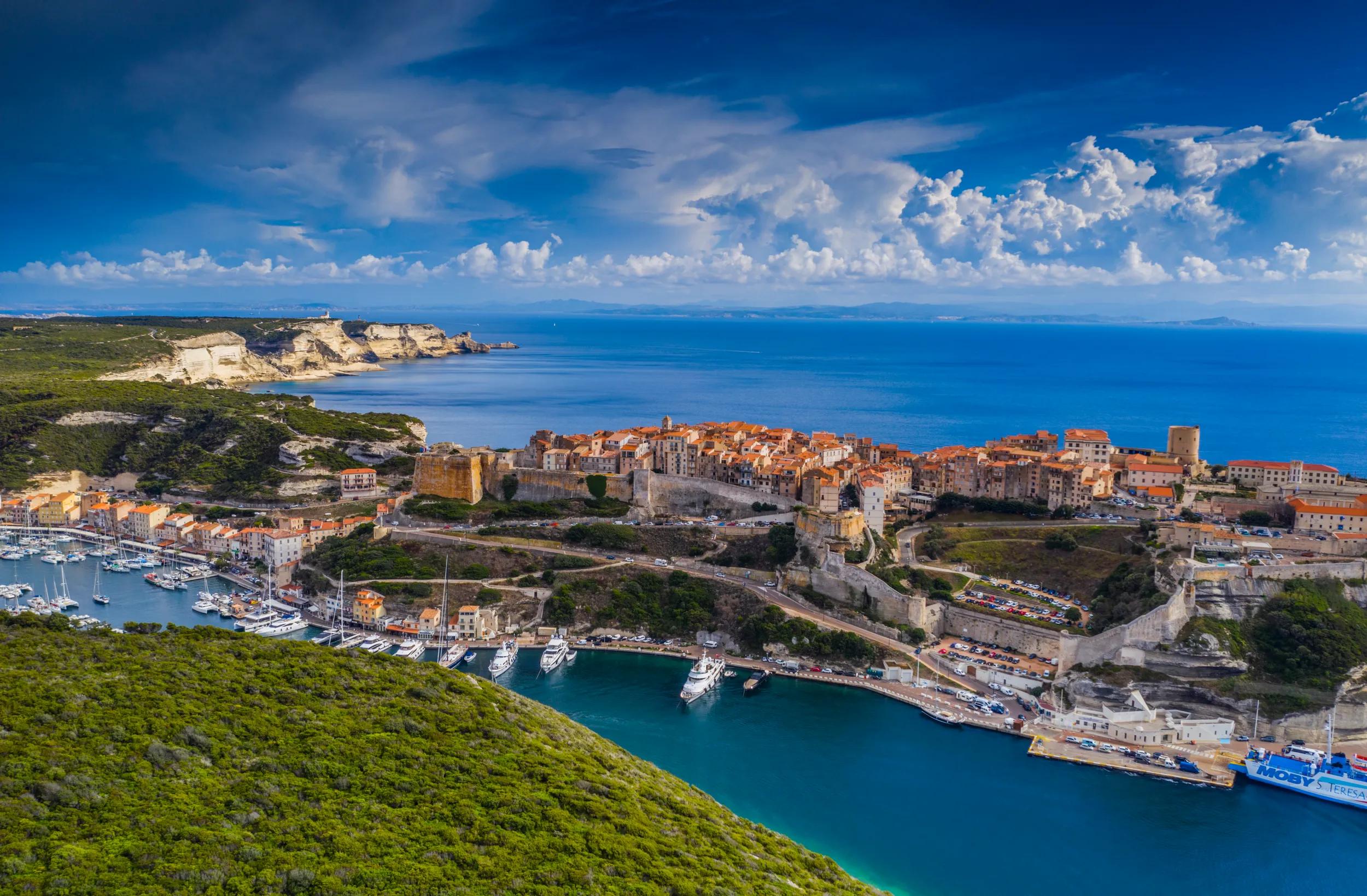 Aerial view of townscape of Bonifacio located on the steep cliffs above the Mediterranean sea in Corsica. Corse-du-Sud, France