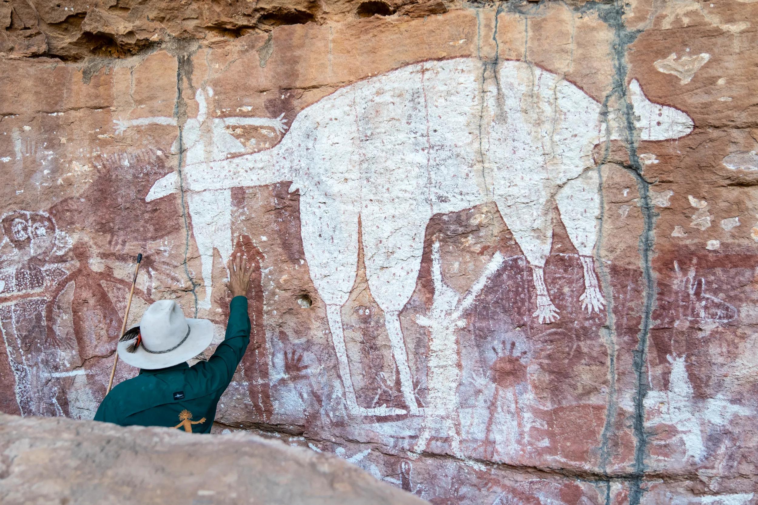 Johnny showing guests the ancient rock art at Magnificant Gallery