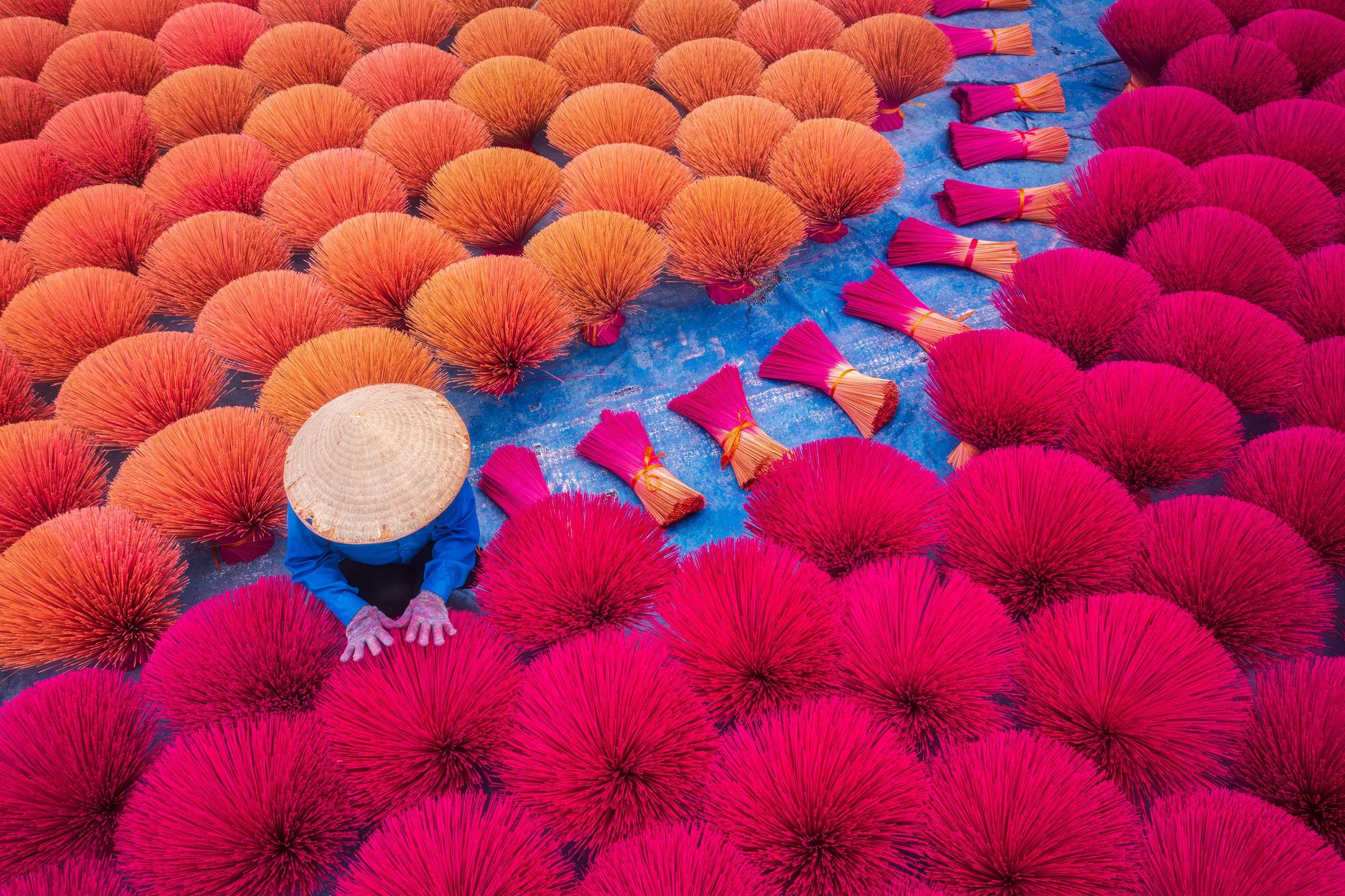 Drone view of a worker is drying incense sticks - a traditional incense of Vietnam - Cau Bau market, Thanh Oai, Ha Noi, North Vietnam