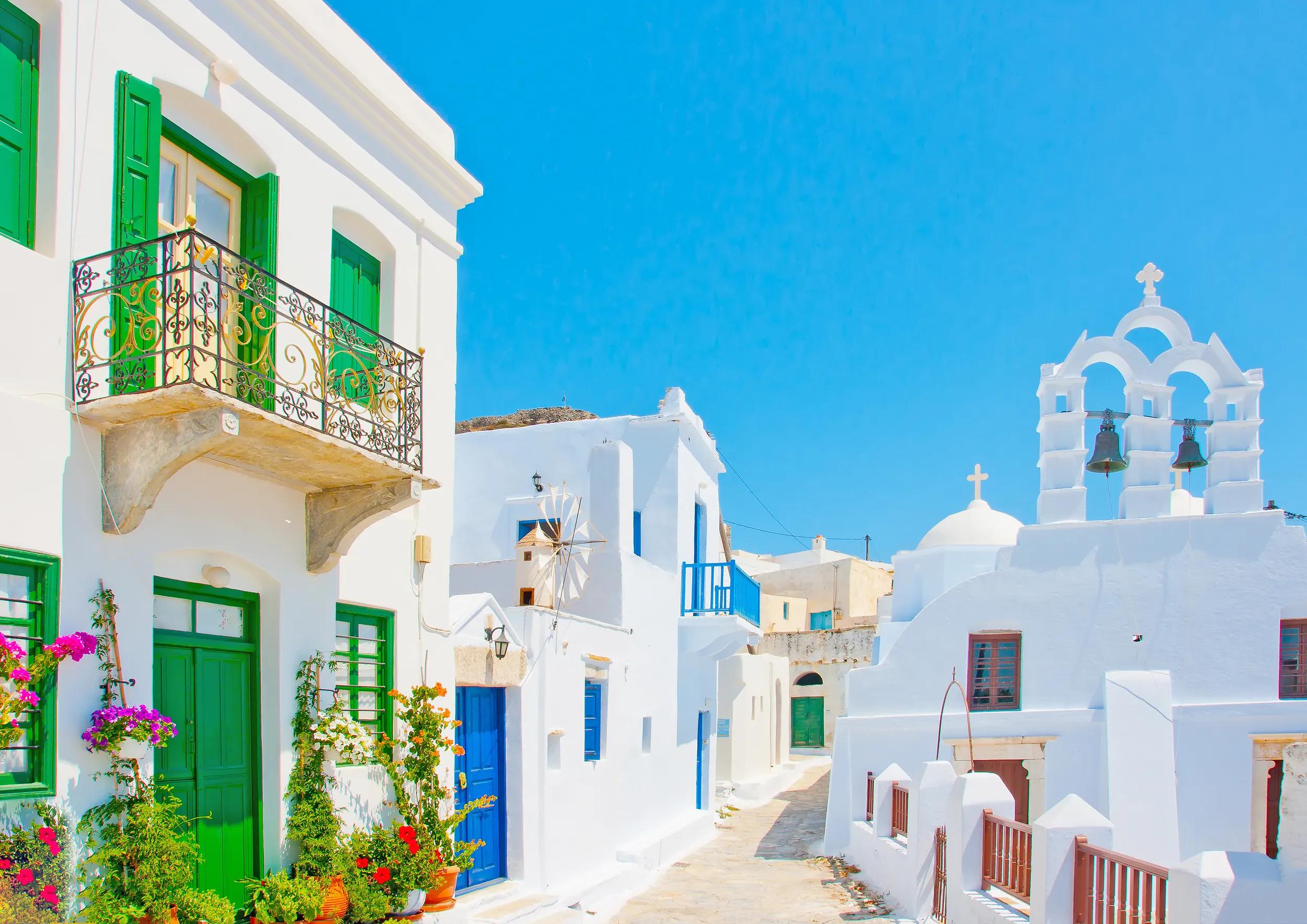 Beautiful stone made road with old traditional houses and a twin church in Chora the capital of Amorgos island in Greece