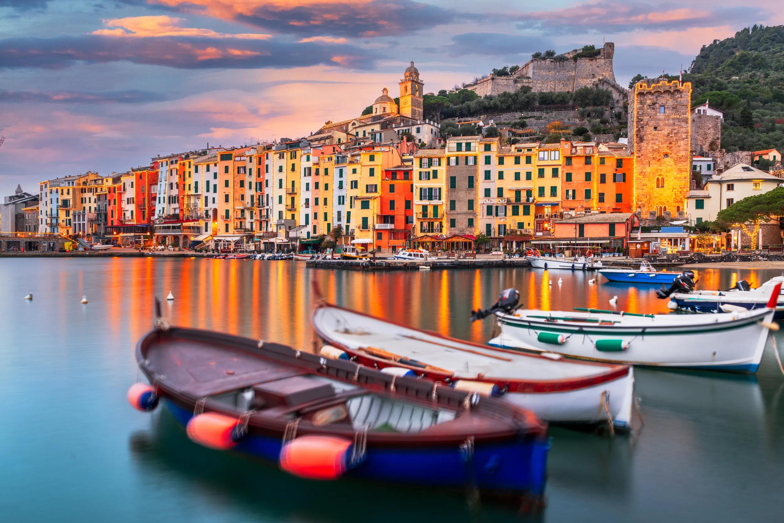 Porto Venere, La Spezia, Italy historic town skyline with Christmas lights at dusk.