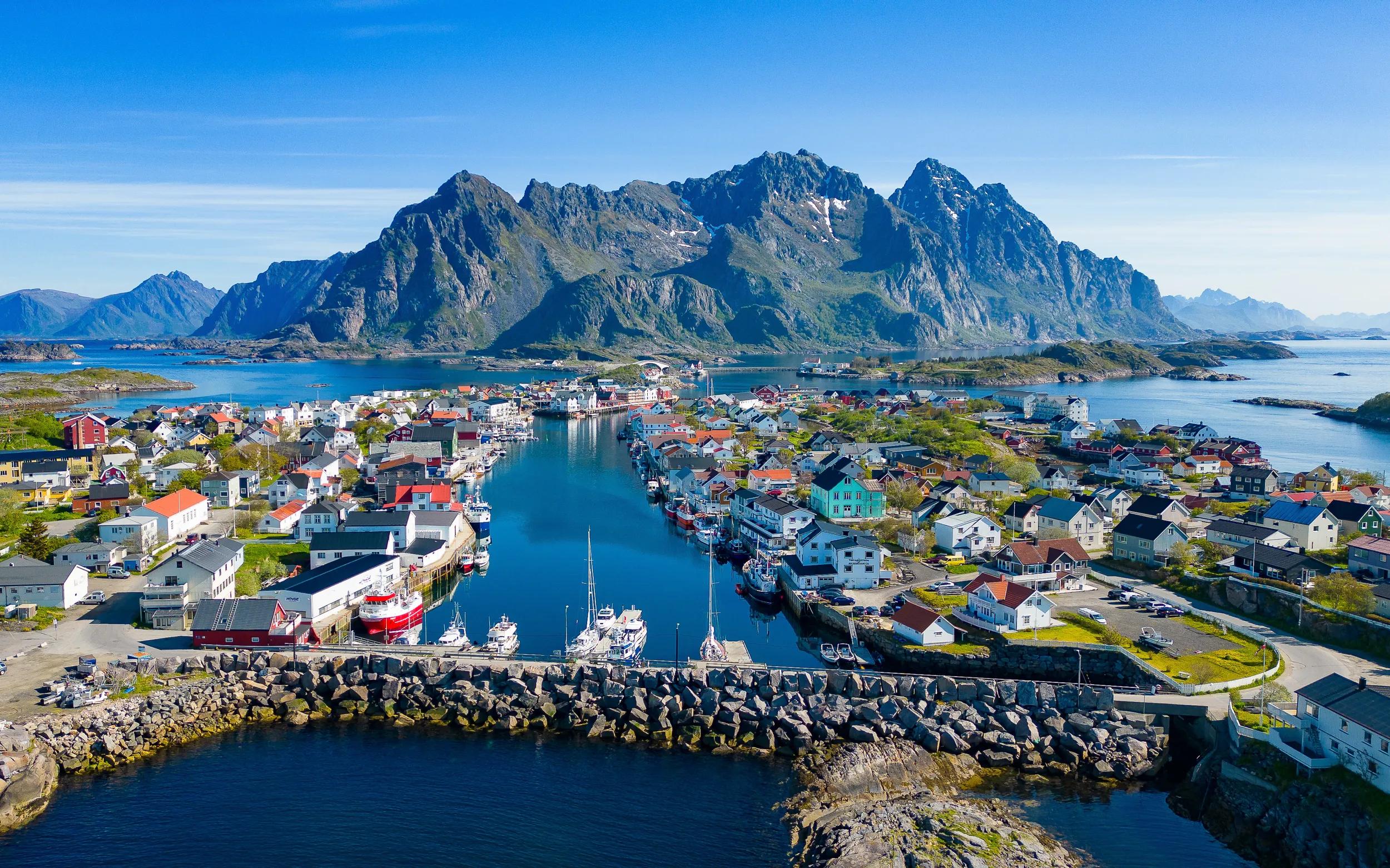 Beautiful fishing village Henningsvaer at Lofoten Islands in Norway. Travel highlight for many tourists on an idyllic summer day.