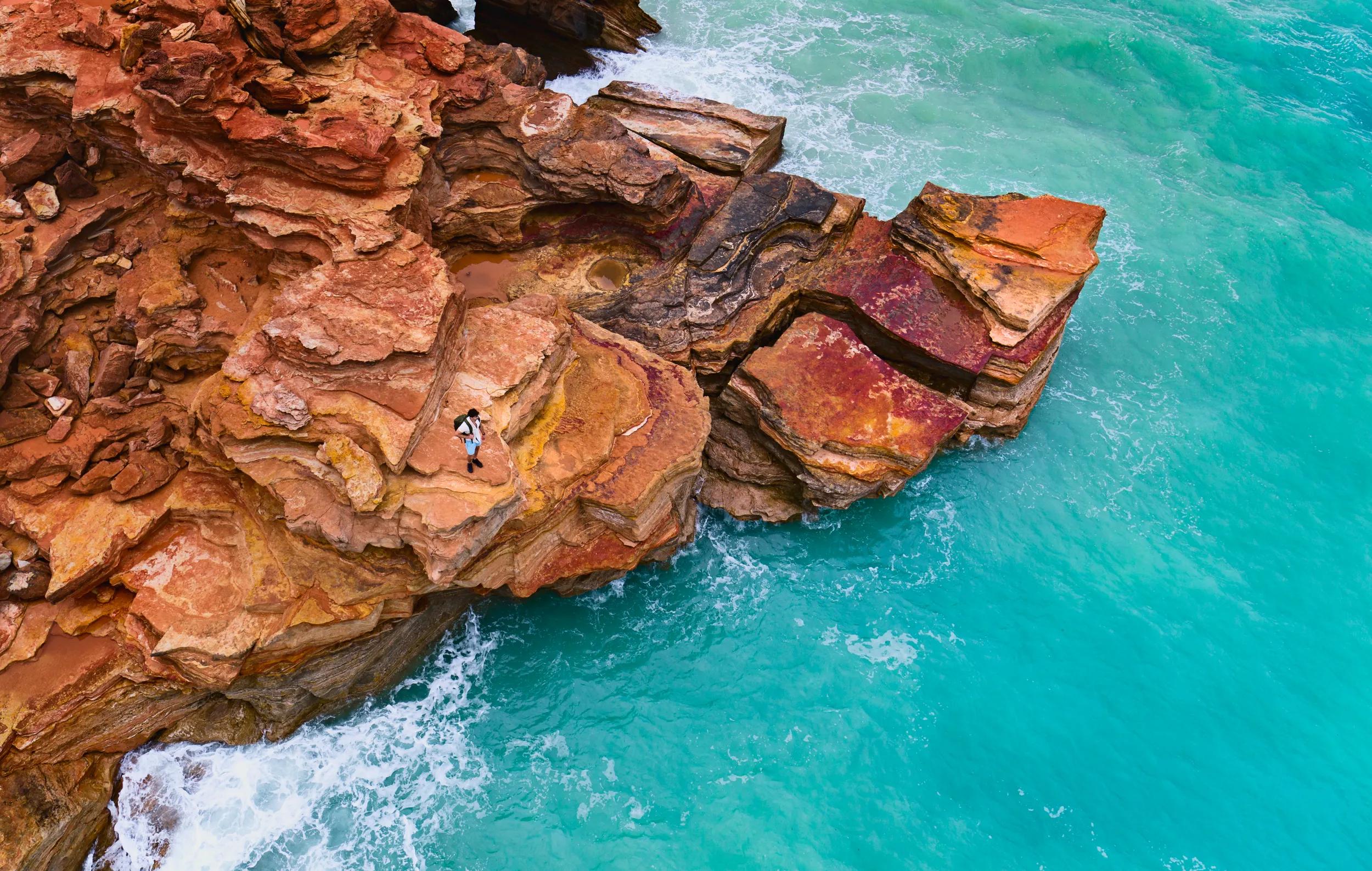 Man standing on rocks at Gantheaume Point, Broome