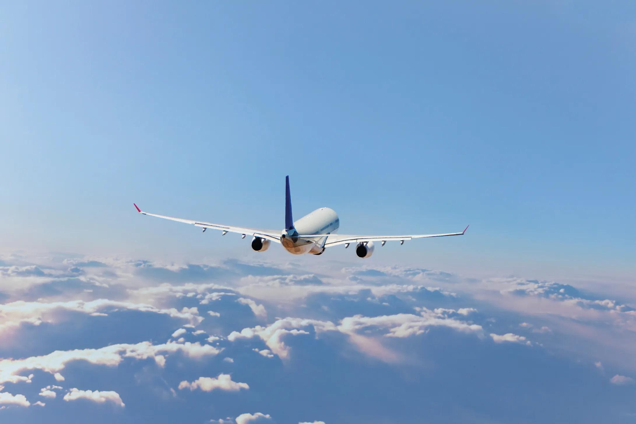 Commercial jet flying over clouds