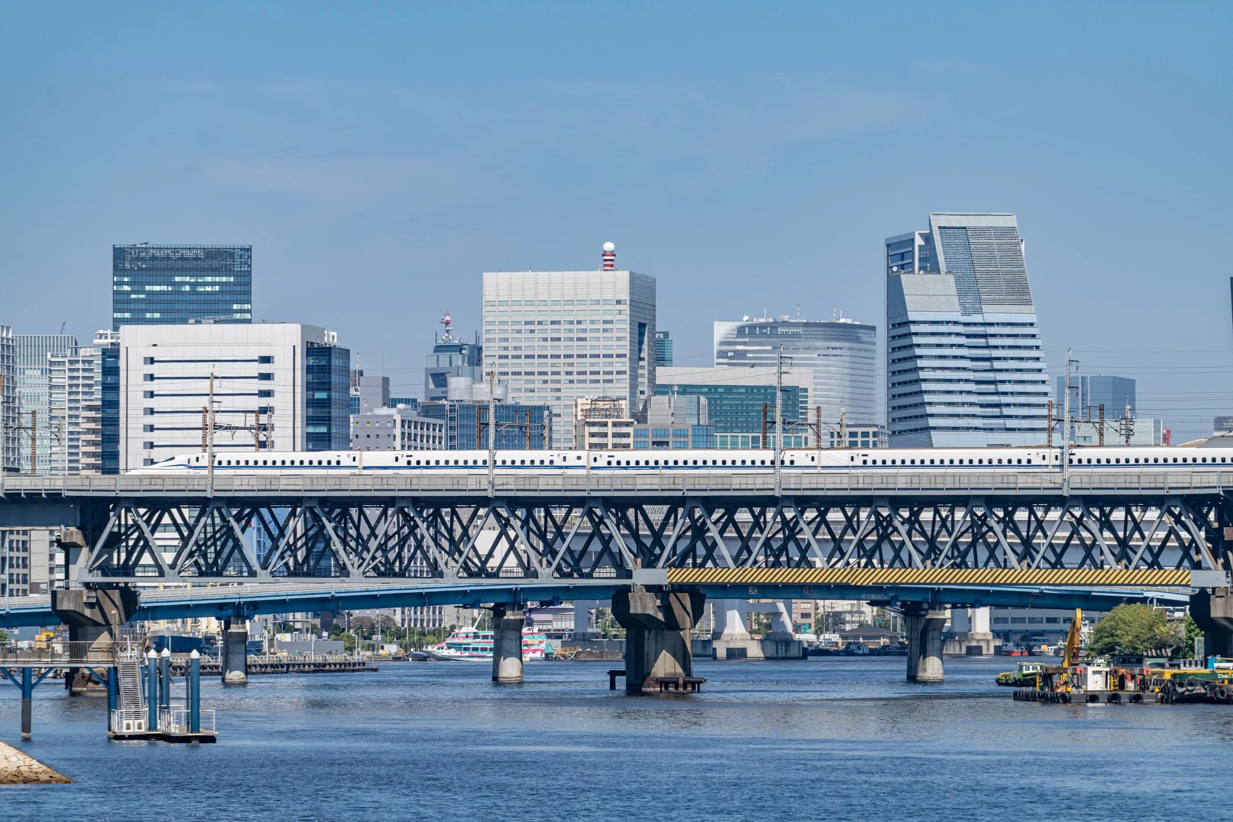 Bullet train running on the bridge over the canal in Tokyo, Japan.