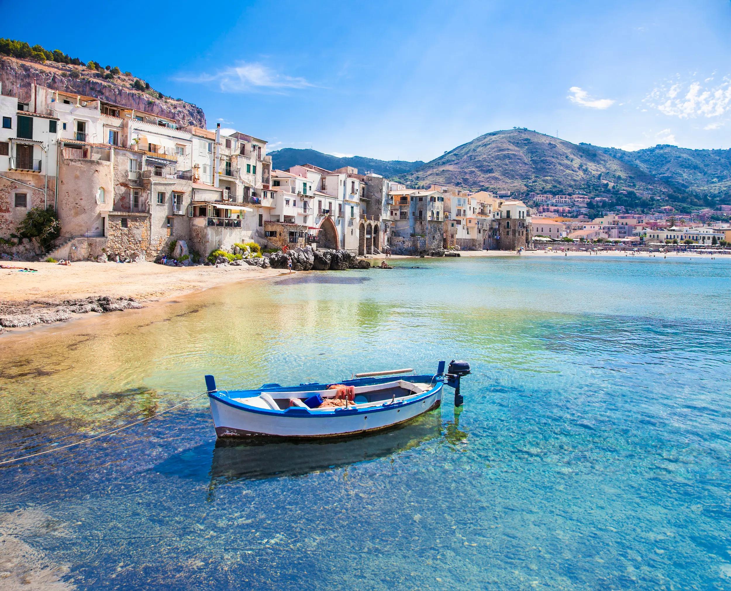 Beautiful old harbor with wooden fishing boat in Cefalu, Sicily, Italy.