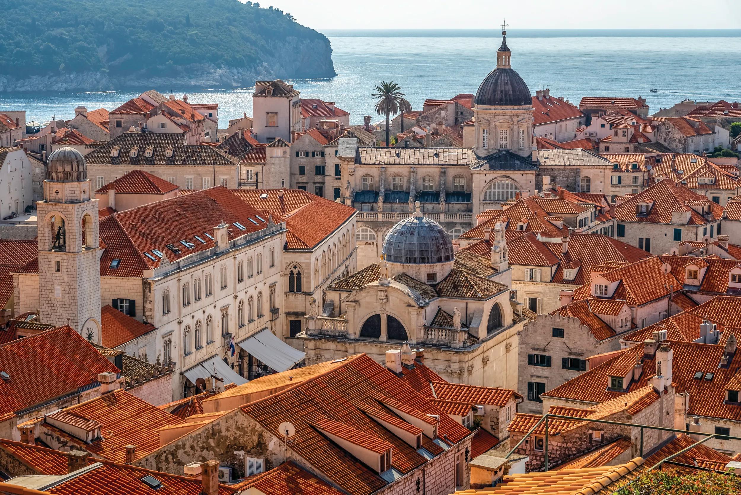The Old City of Dubrovnik situated on the Dalmatian coast became an important Mediterranean sea power from the 13th century onwards. Although severely damaged by an earthquake in 1667, Dubrovnik managed to preserve its beautiful Gothic, Renaissance, and Baroque churches, monasteries, palaces, and fountains. Damaged again in the 1990s by armed conflict, it is now the focus of a major restoration program co-ordinated by UNESCO. The orange-tiled roofs are one of Dubrovnik Old Town signatures..The Town Center view from the City Wall in this picture you can see the famous attractions including the Church of Saint Blaise, Rector's Palace and Dubrovnik Cathedral.