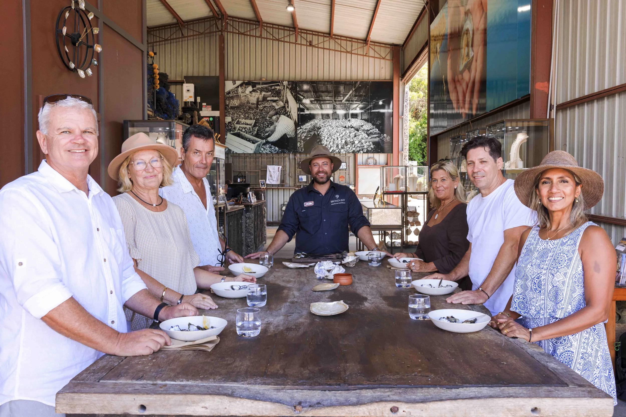 Group of people oyster tasting, Broken Bay Pearl Farm, NSW, Australia.