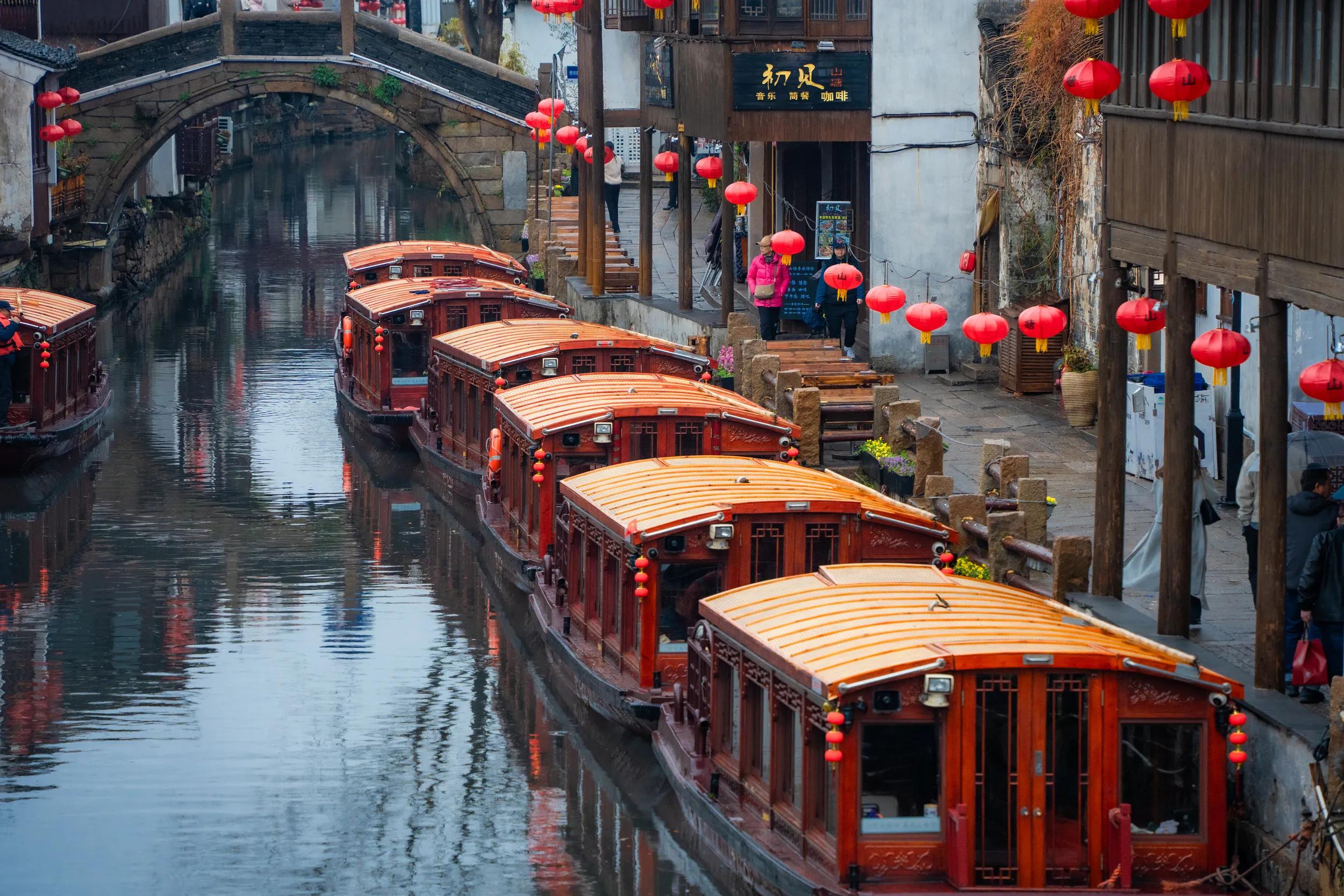 Serene water town landscape in Suzhou, known as "Venice of the East" for its canals and waterways connected by charming stone bridges.