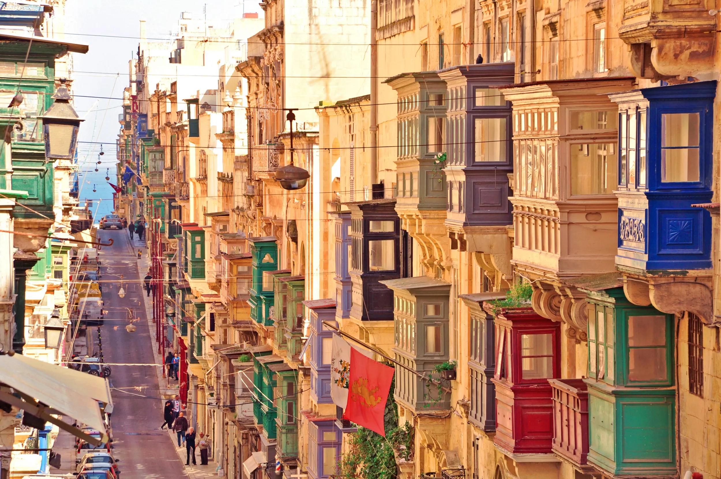 Famous landmark of hilly road with colourful balconies in the ancient city of Valletta, Malta