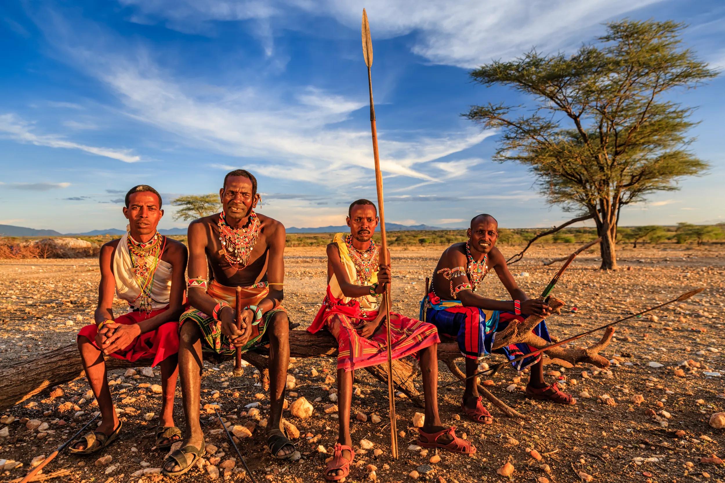 African warriors from Samburu tribe resting on savanna, central Kenya. Samburu tribe is one of the biggest tribes of north-central Kenya, and they are related to the Maasai.