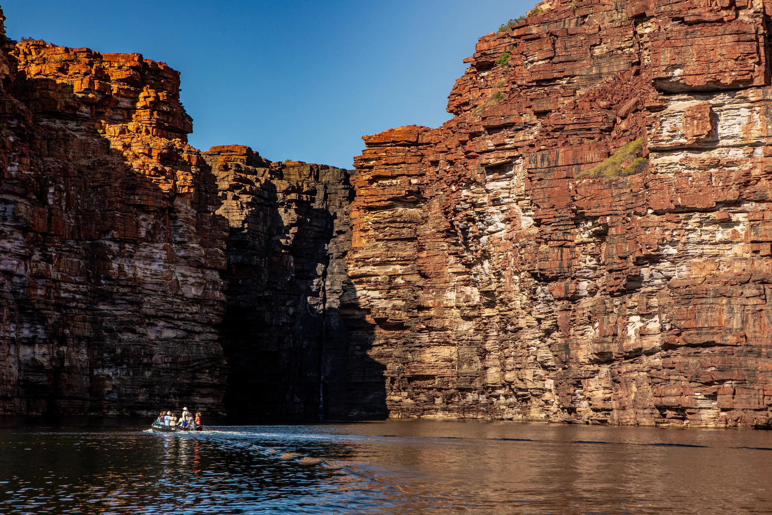 low angel view from the King George River in the Kimberleys in Western Australia, out of a zodiac boat with lush mangroves and dramatic limestones