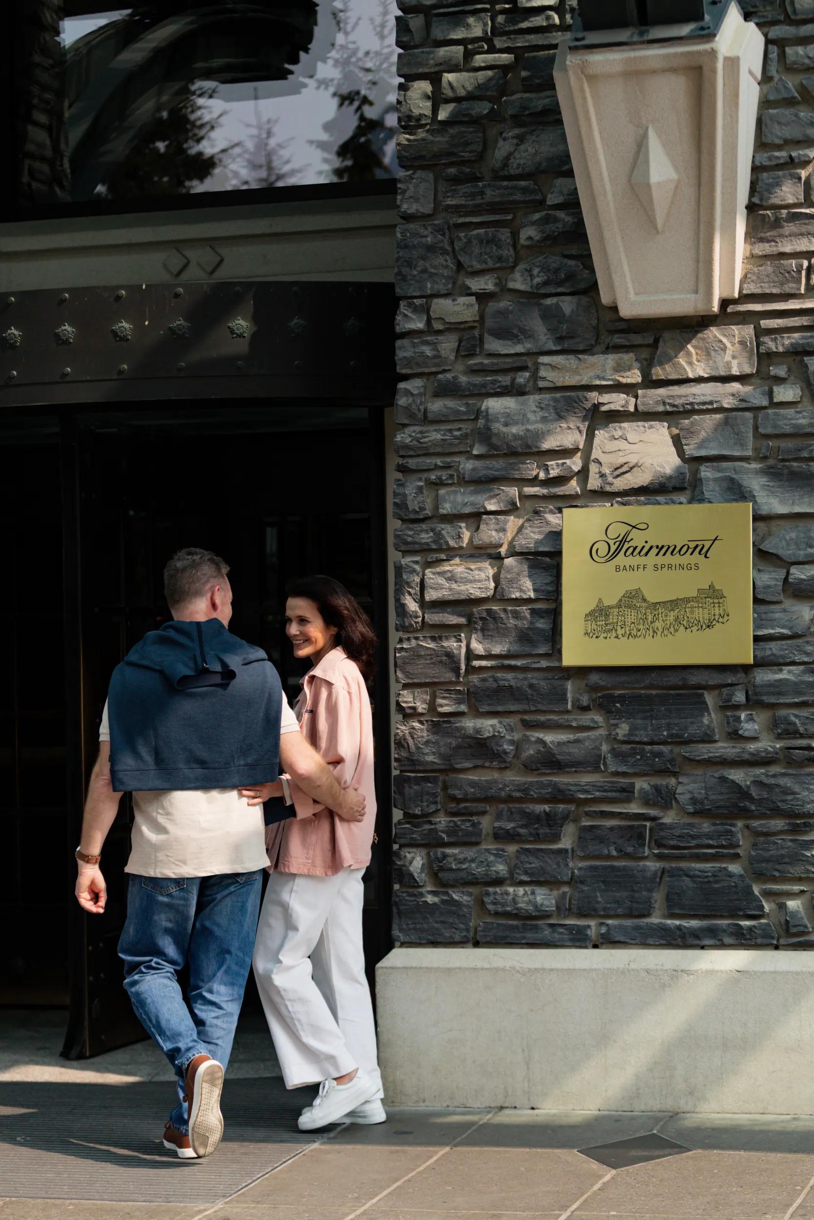 Couple at entry to Fairmont Banff Springs Hotel.