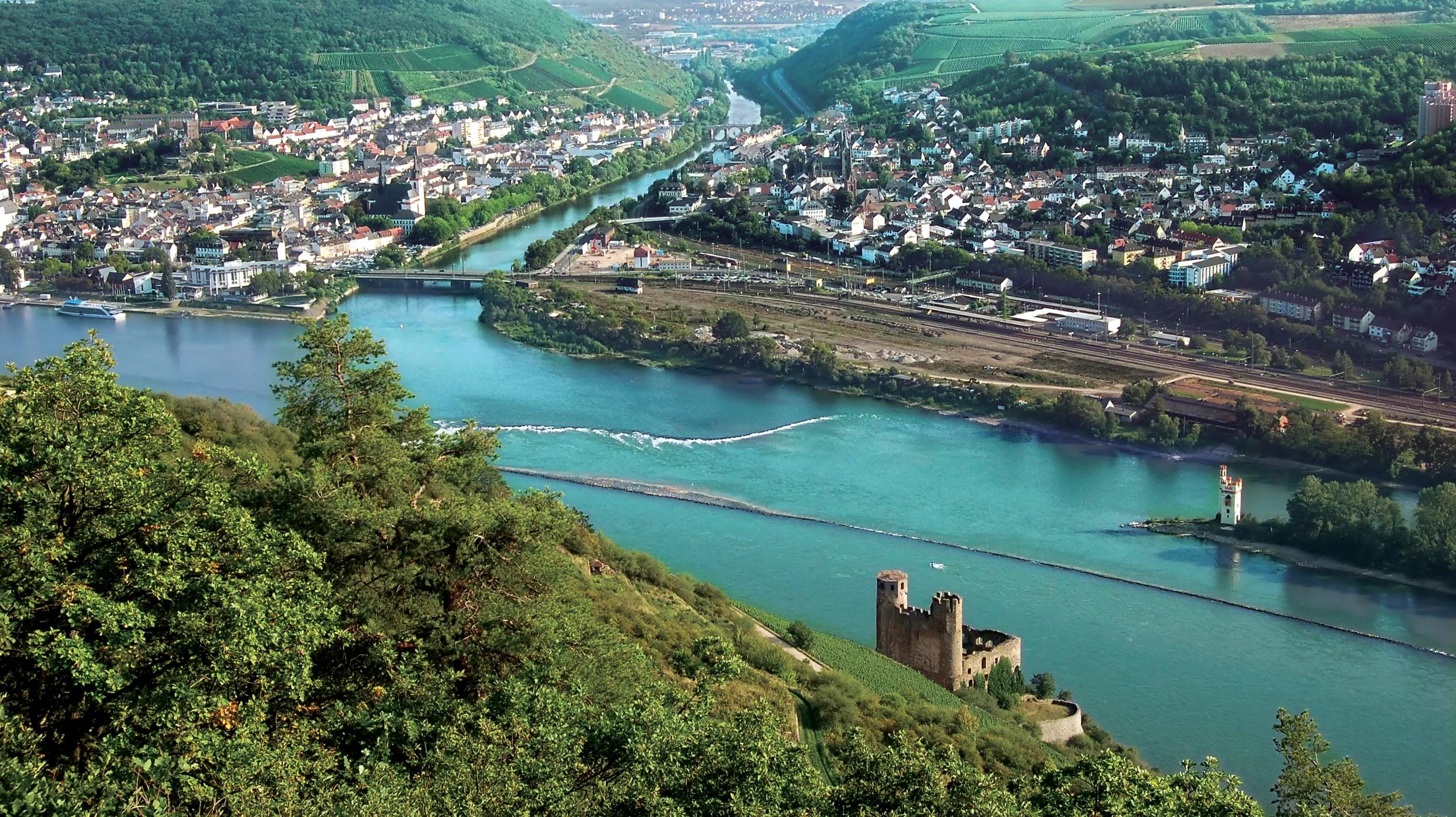 Rhine River with Bingen on upper riverside, Ehrenfels Castle in the foreground and The Mouse Tower on small island.