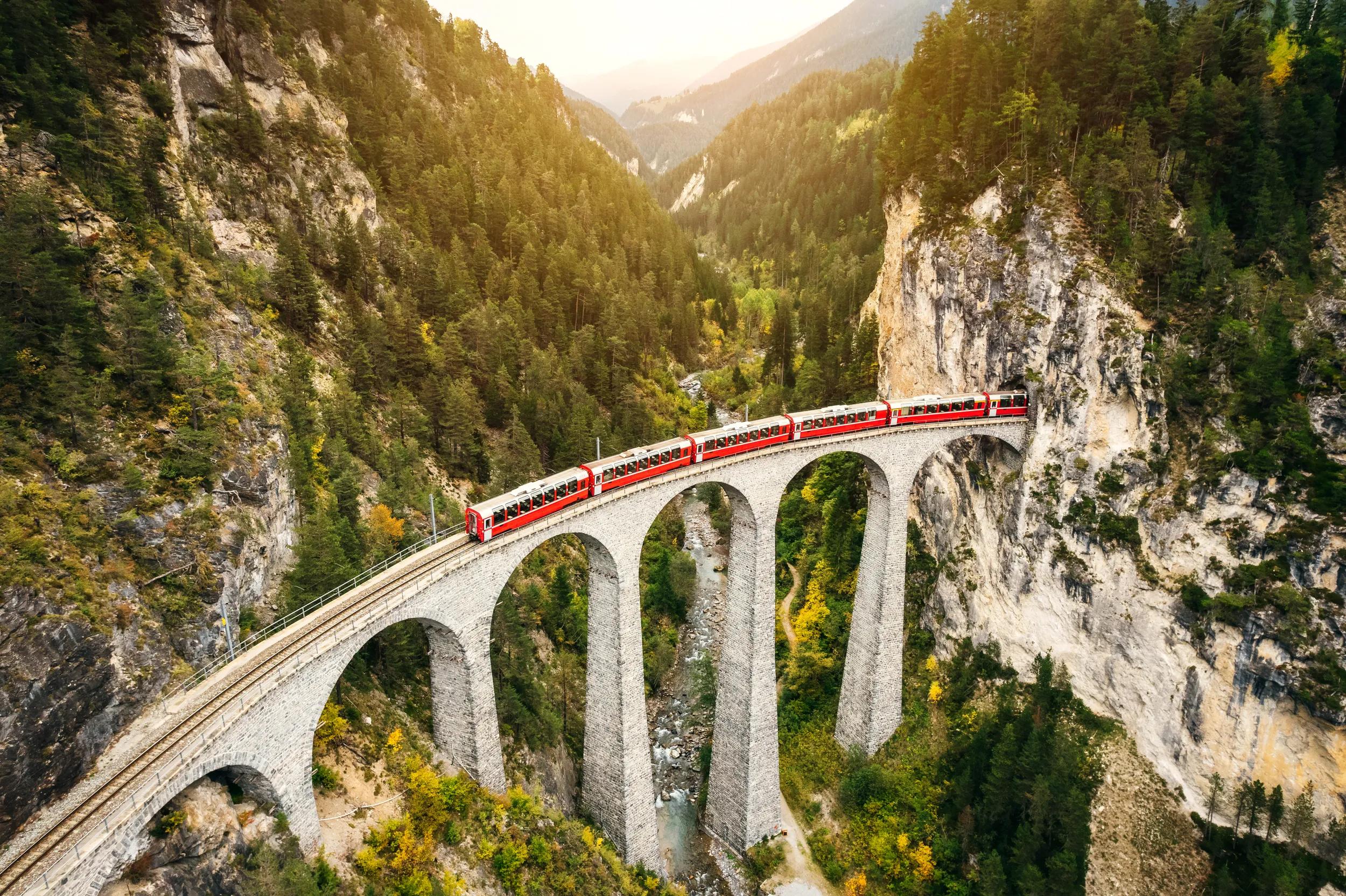 Train crossing Landwasser Viaduct on raethian railway in Filisur – Albula, Graubunden, Switzerland .The Landwasser Viaduct is a single track limestone railway viaduct near Filisur in the canton of Graubünden, Switzerland.