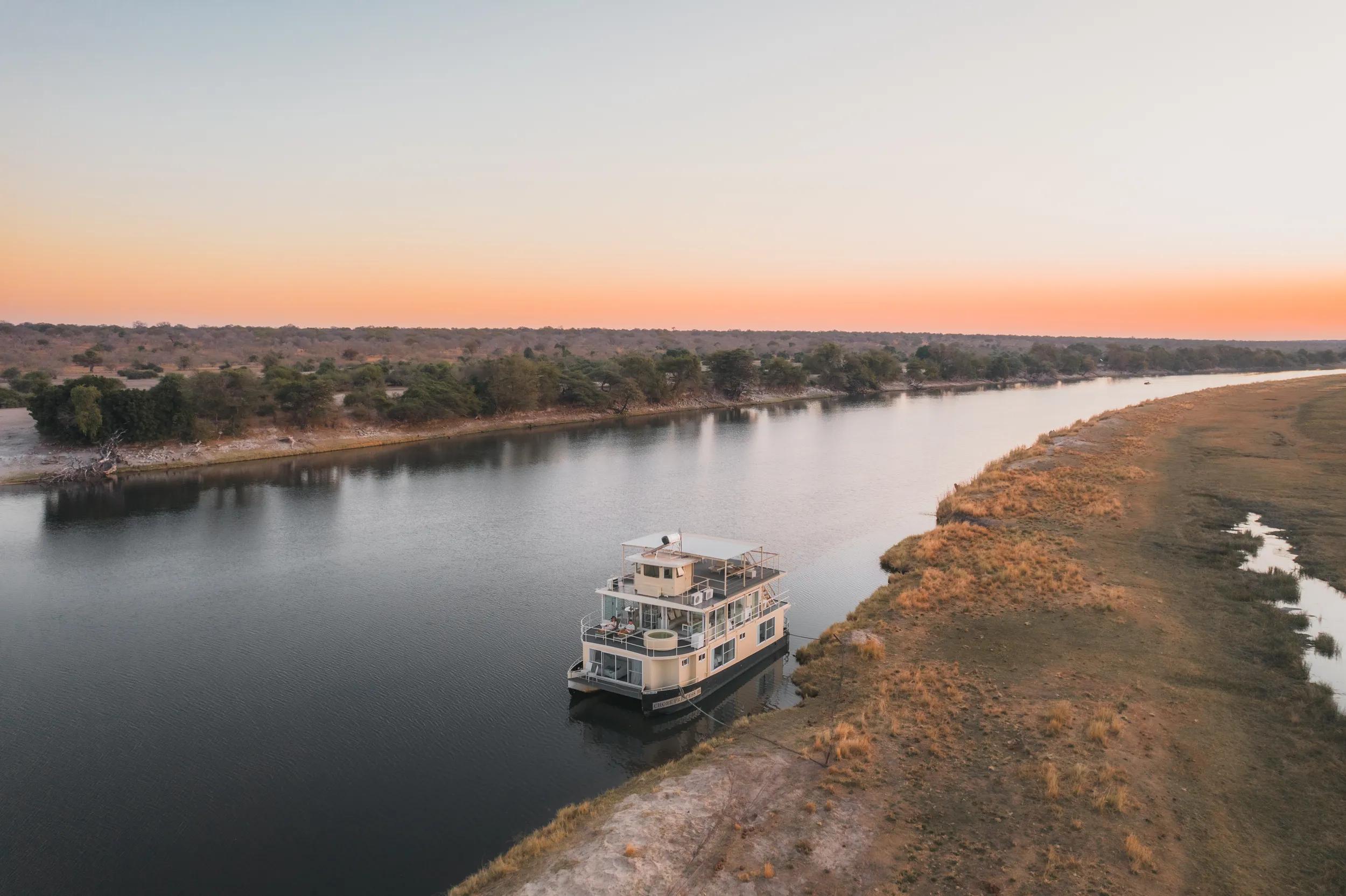 Chobe Princess Houseboat - Exterior at sunset moored on river back.