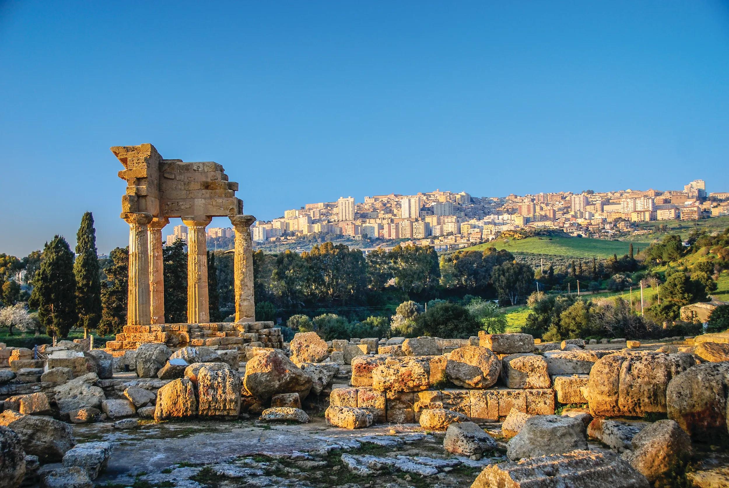 Temple of Castor and Pollux ruins with new Agrigento in the background.