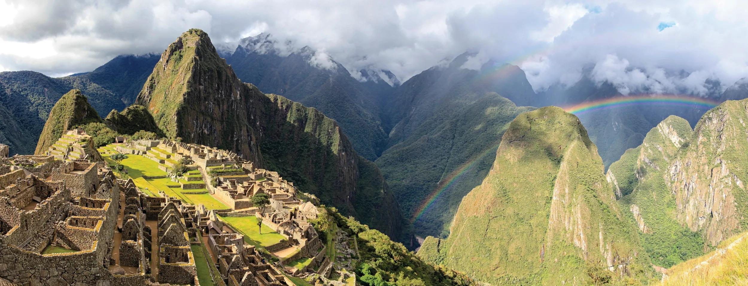 Classic postcard picture of Macchu Picchu in late afternoon with rainbow in the background. Peru. For more Macchu Picchu images please click here: