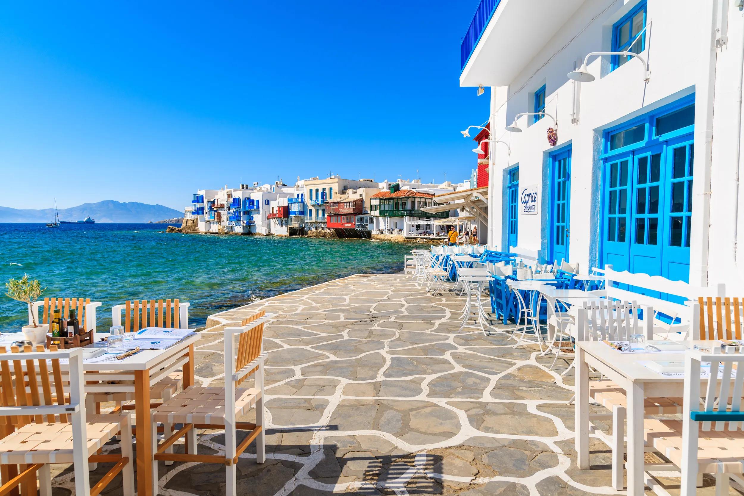 MYKONOS ISLAND, GREECE - MAY 16, 2016: Typical Greek tavern in Little Venice, a part of Mykonos town on island of Mykonos, Greece.