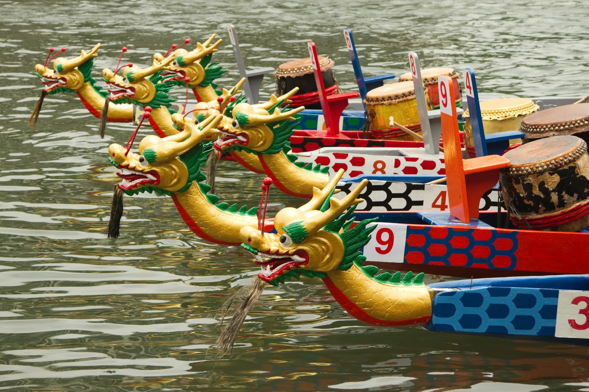A dragon boat (also dragonboat) is a human-powered boat (Paddled Water Craft) traditionally made of teak wood to various designs and sizes. Dragon boats are generally rigged with decorative Chinese dragon heads and tails.