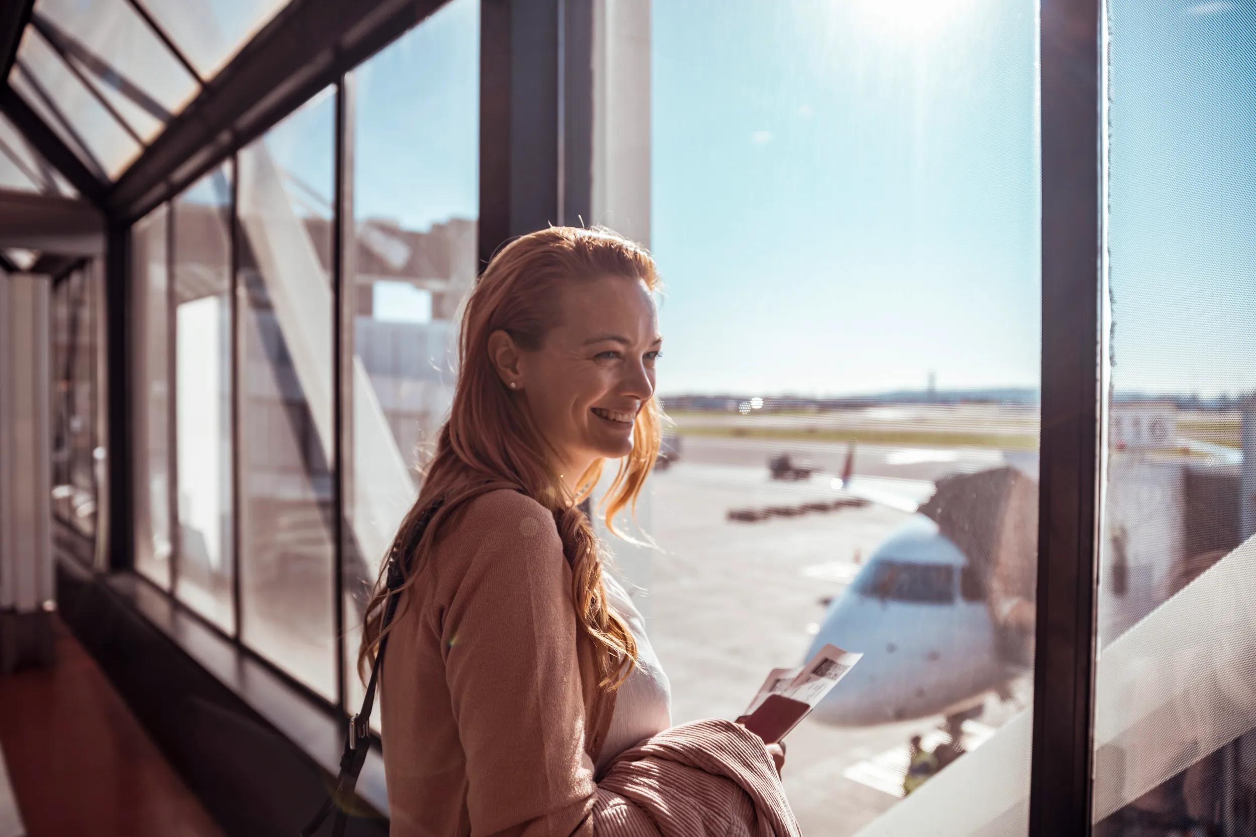Close up of a young woman waiting to board the airplane at the airport