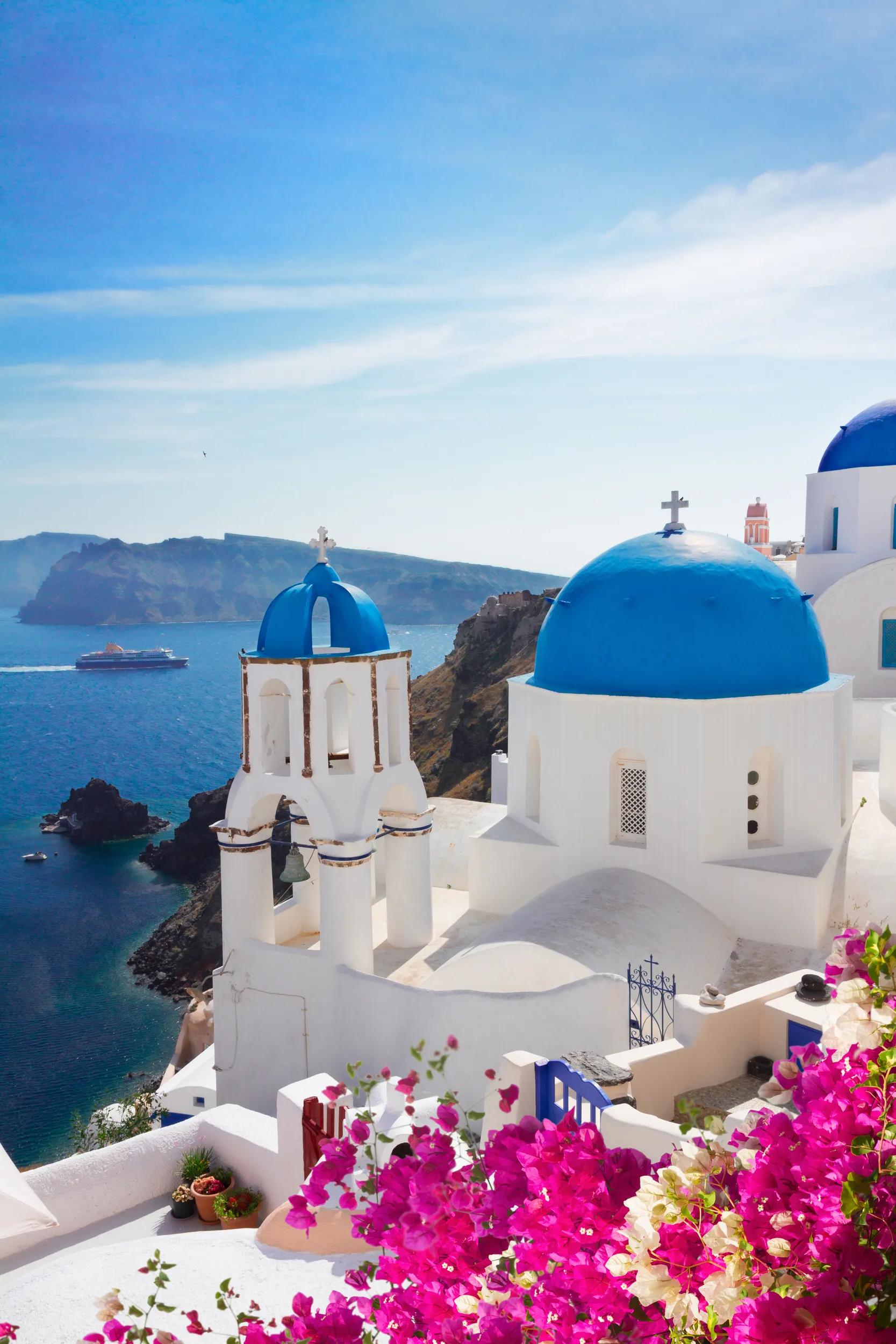 volcano caldera with blue church domes and belfry, Oia village, Santorini