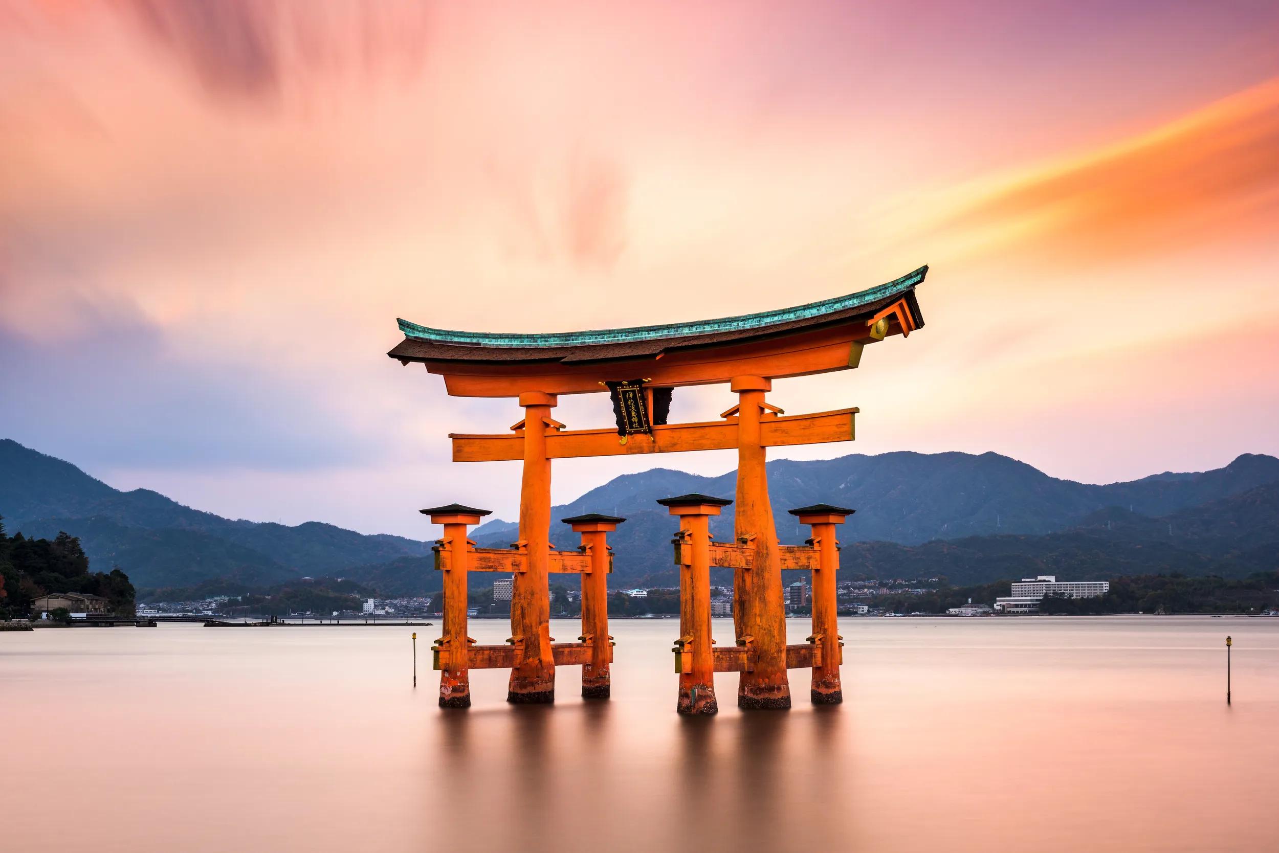 Miyajima, Hiroshima, Japan at the floating gate of Itsukushima Shrine. (gate sign reads Itsukushima Shrine)
