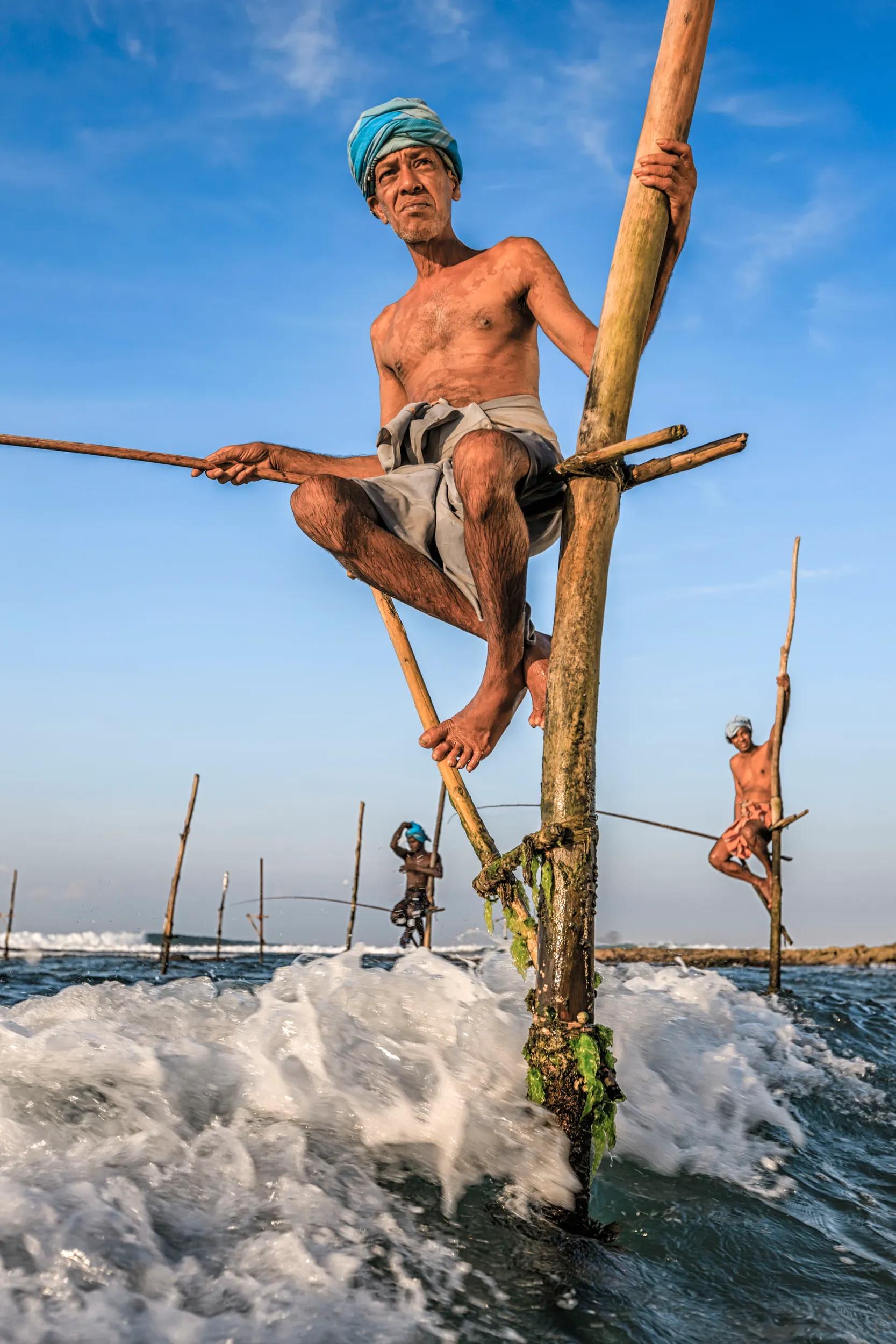 A close-up of a stilt fishermen working near Galle town, Sri Lanka, Asia. Stilt Fishing is one of the most interesting traditional fishing methods in Asia