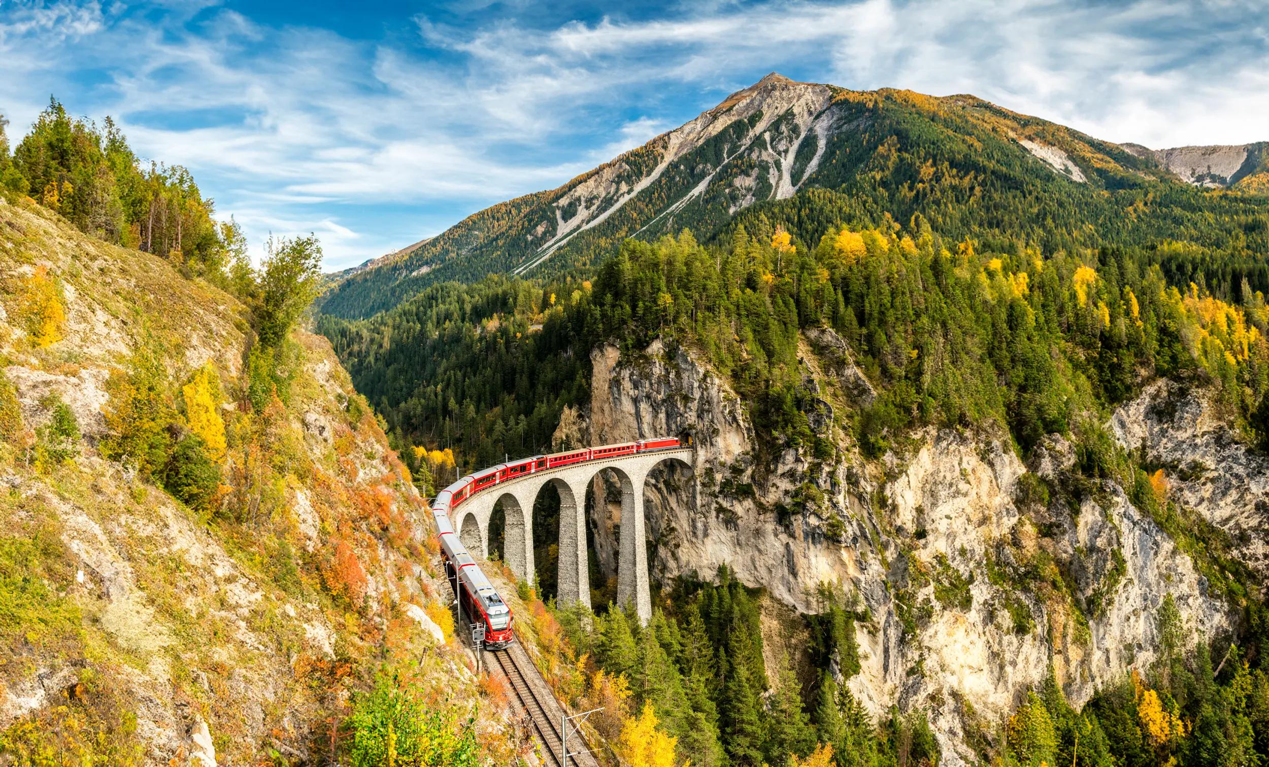 Bernina Express Train traveling on Landwasser Viaduct in autumn, Filisur, canton of Graubunden, Switzerland