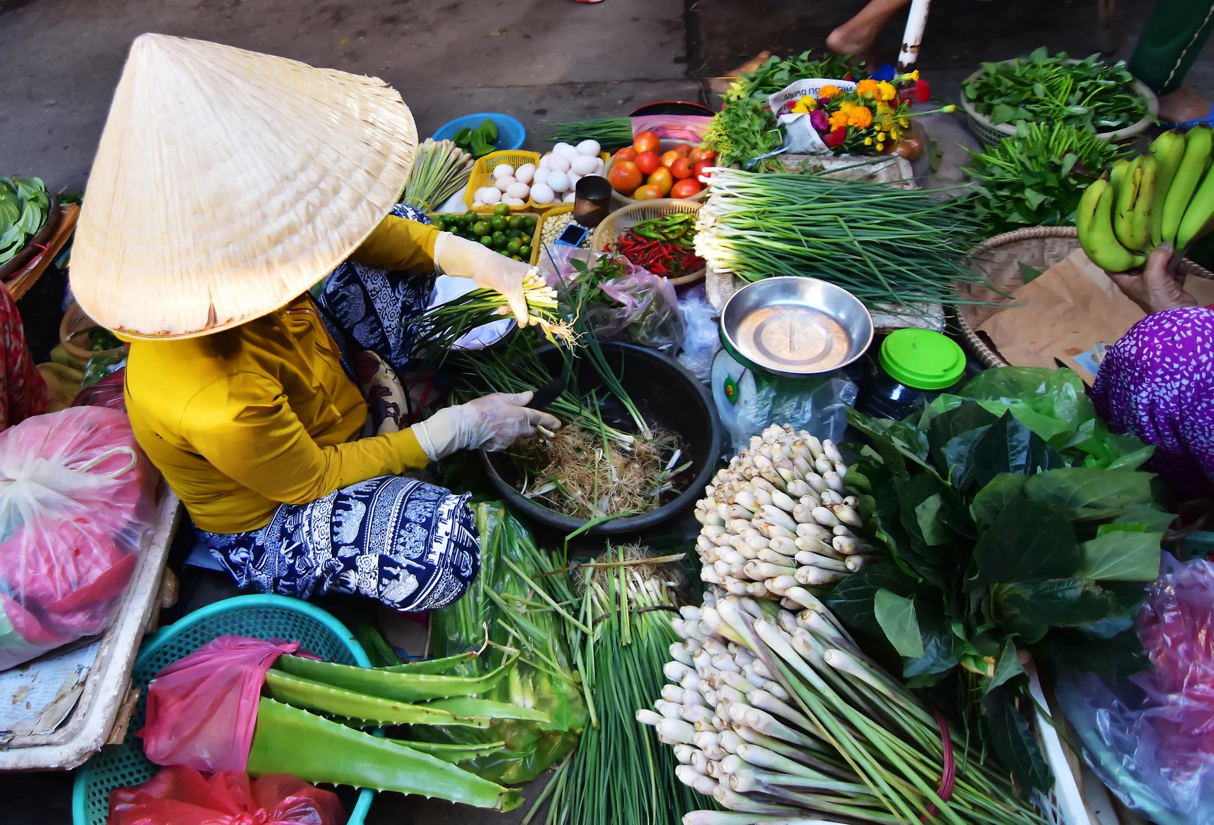 Vietnamese vendor sell vegetables in the  morning at local market in Vietnam