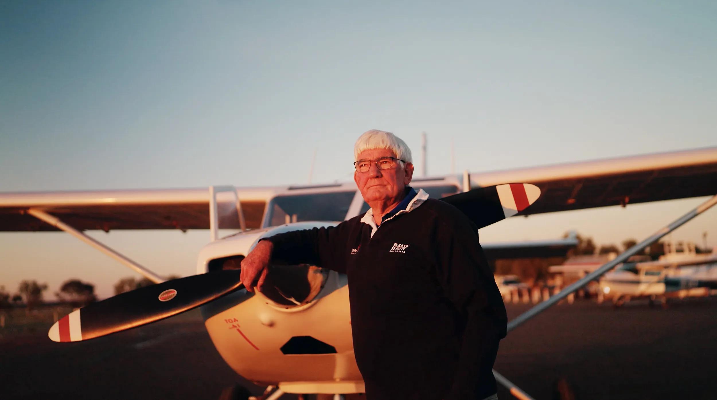 Wrightsair - Trevor Wright standing near plane propeller at sunset, front view.