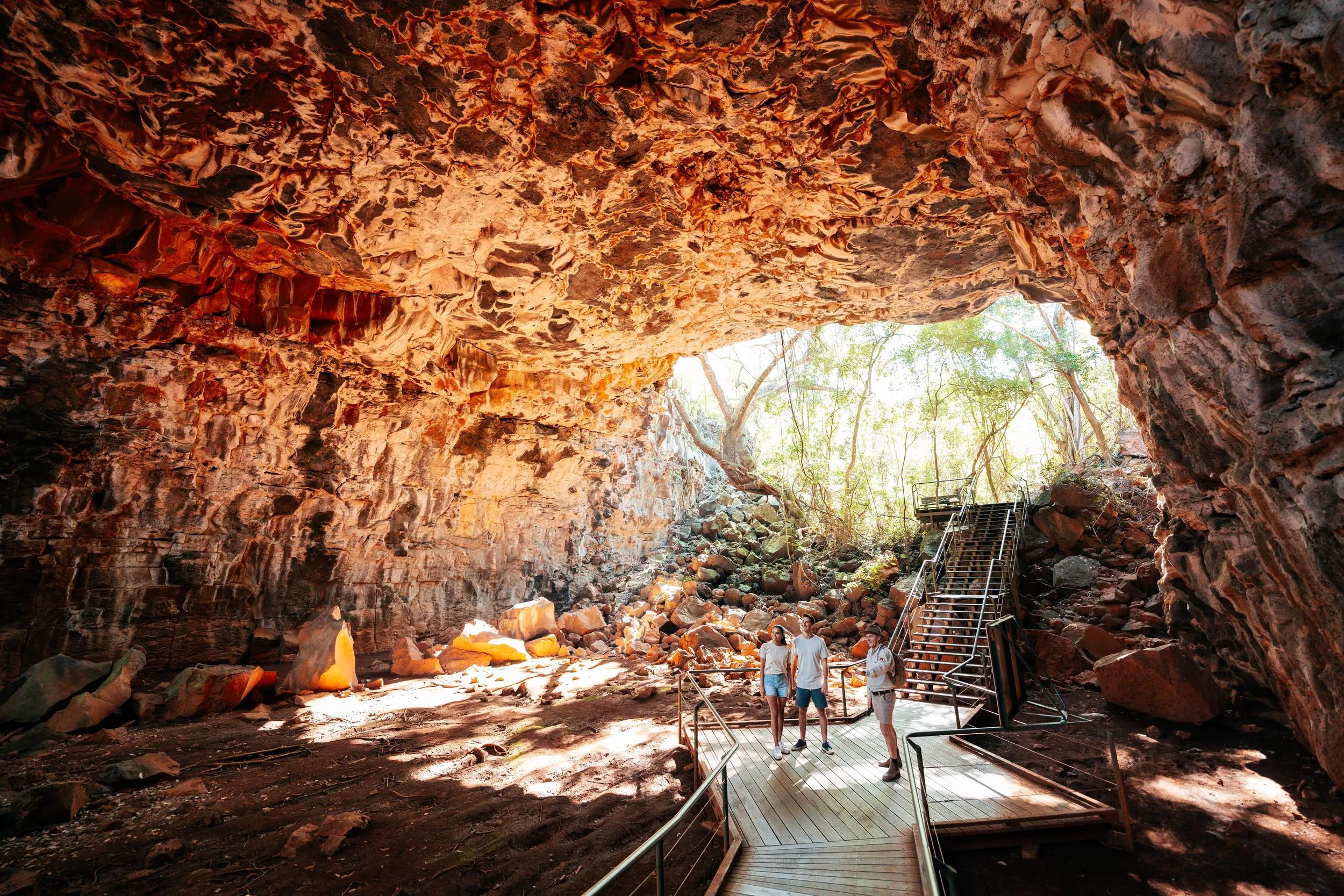 Tours, experiences and accommodation on the edge of the Undara Volcanic National Park. Couple enjoying the guided Archway Explorer Lava Tube Tour.