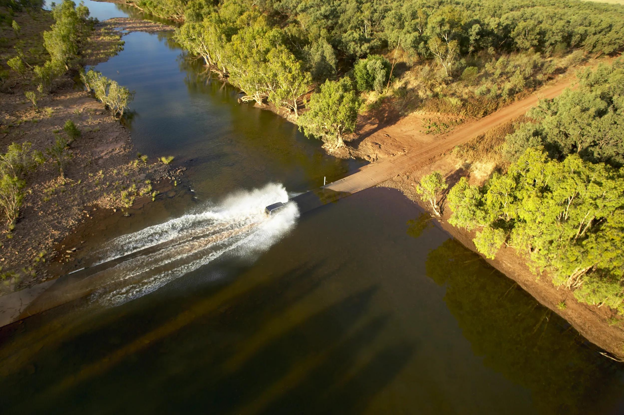 Four-wheel drive travelling along the Buchanan Highway, part of the Savannah Way.Load up the 4WD and hit the Savannah Way to experience this journey-of-a-lifetime across the vast Australian continent. Make your way through the Australian tropics along the incredible 3700km route, from Cairns in Queensland, through the Northern Territory, and on to Broome in Western Australia.