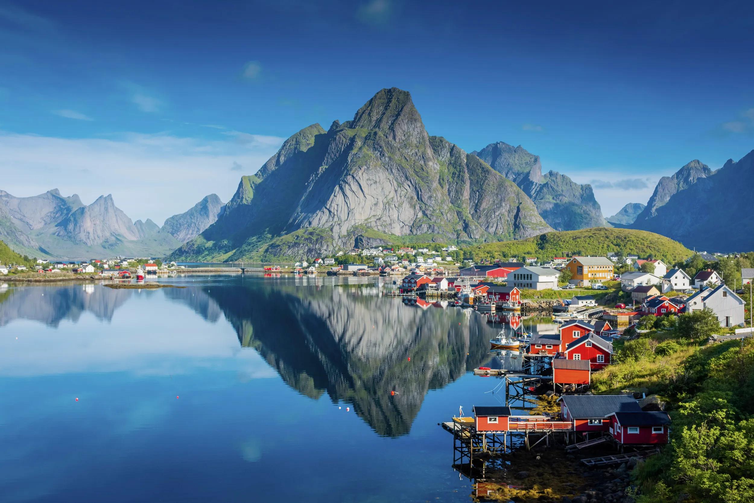 Perfect reflection of the Reine village on the water of the fjord in the Lofoten Islands, Norway