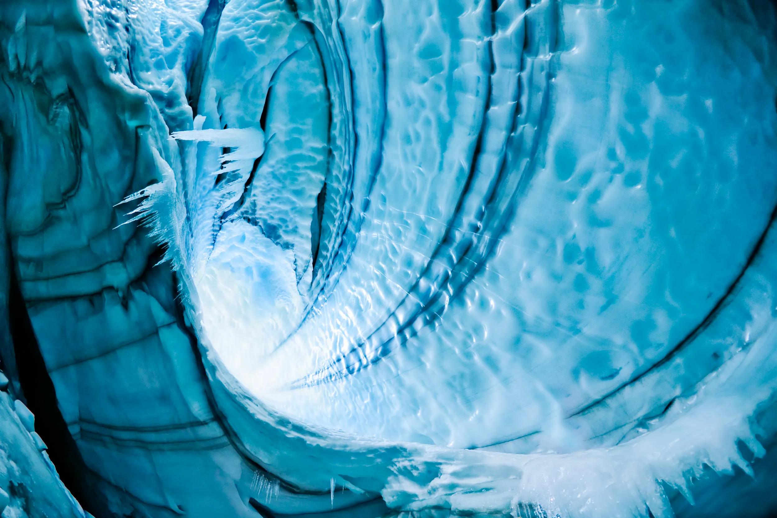 Langjokull Glacier, Iceland. Caves are formed from either hot springs underneath glacier or meltwater from surface. Climber is 80 feet below surface of glacier