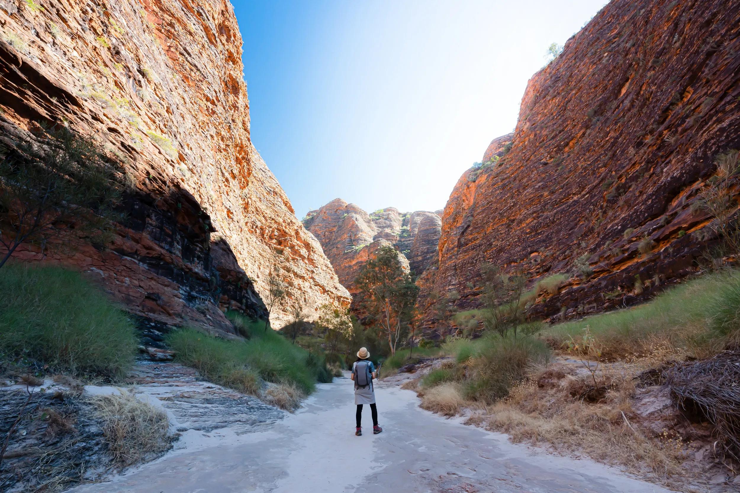 A lday is walking into Bungle Bungles valley in Purnululu National Park, Kimberley, Western Australia
