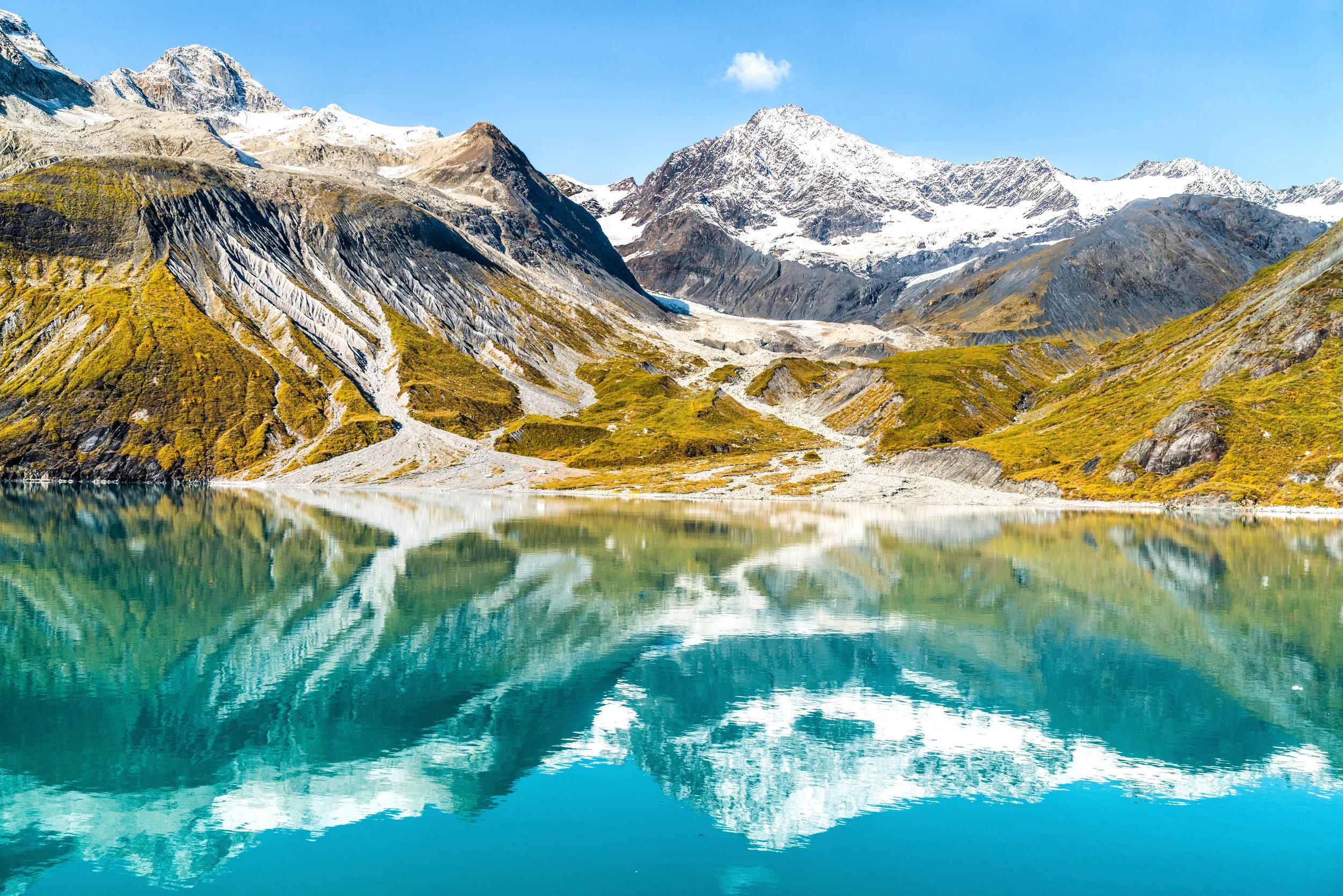 Glacier Bay National Park, Alaska, USA. Amazing glacial landscape showing mountain peaks and glaciers on clear blue sky summer day.