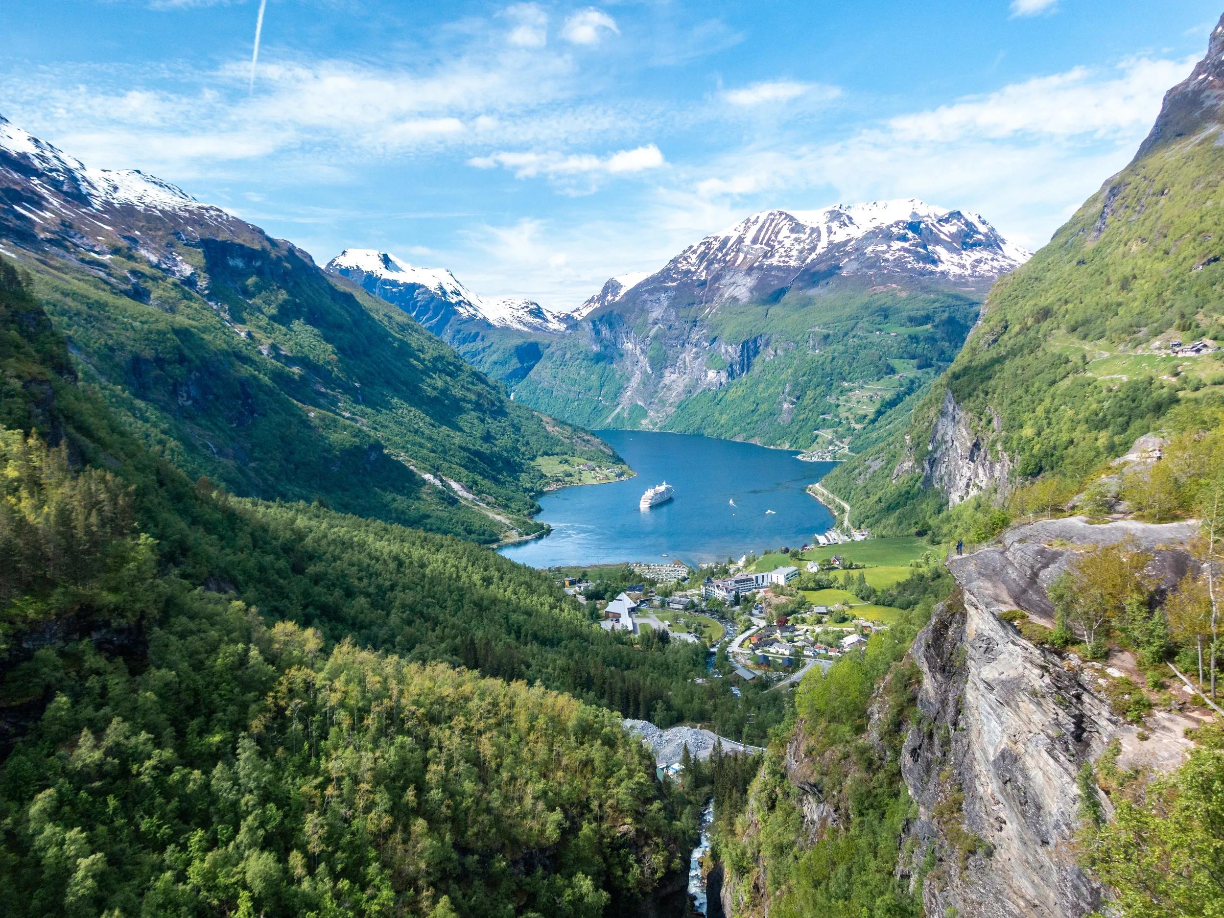 Geiranger leading into Gierangerfjord from the snowcapped Dalsnibba Pass mountain top viewpoint.