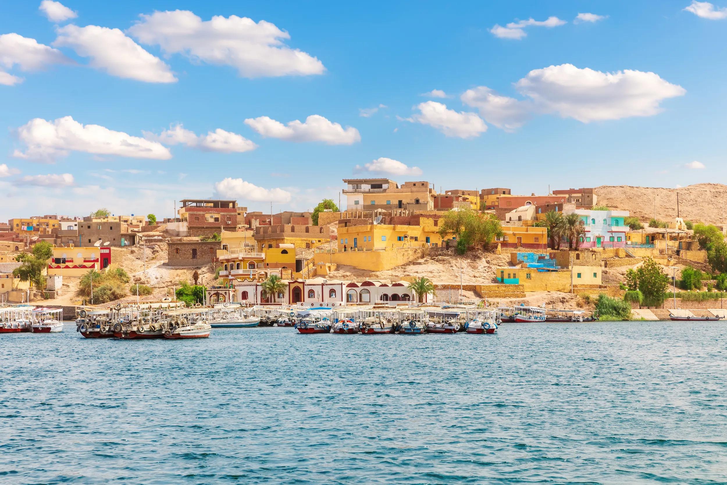 Egyptian village by the Philae Temple, view from the Nile, Aswan.