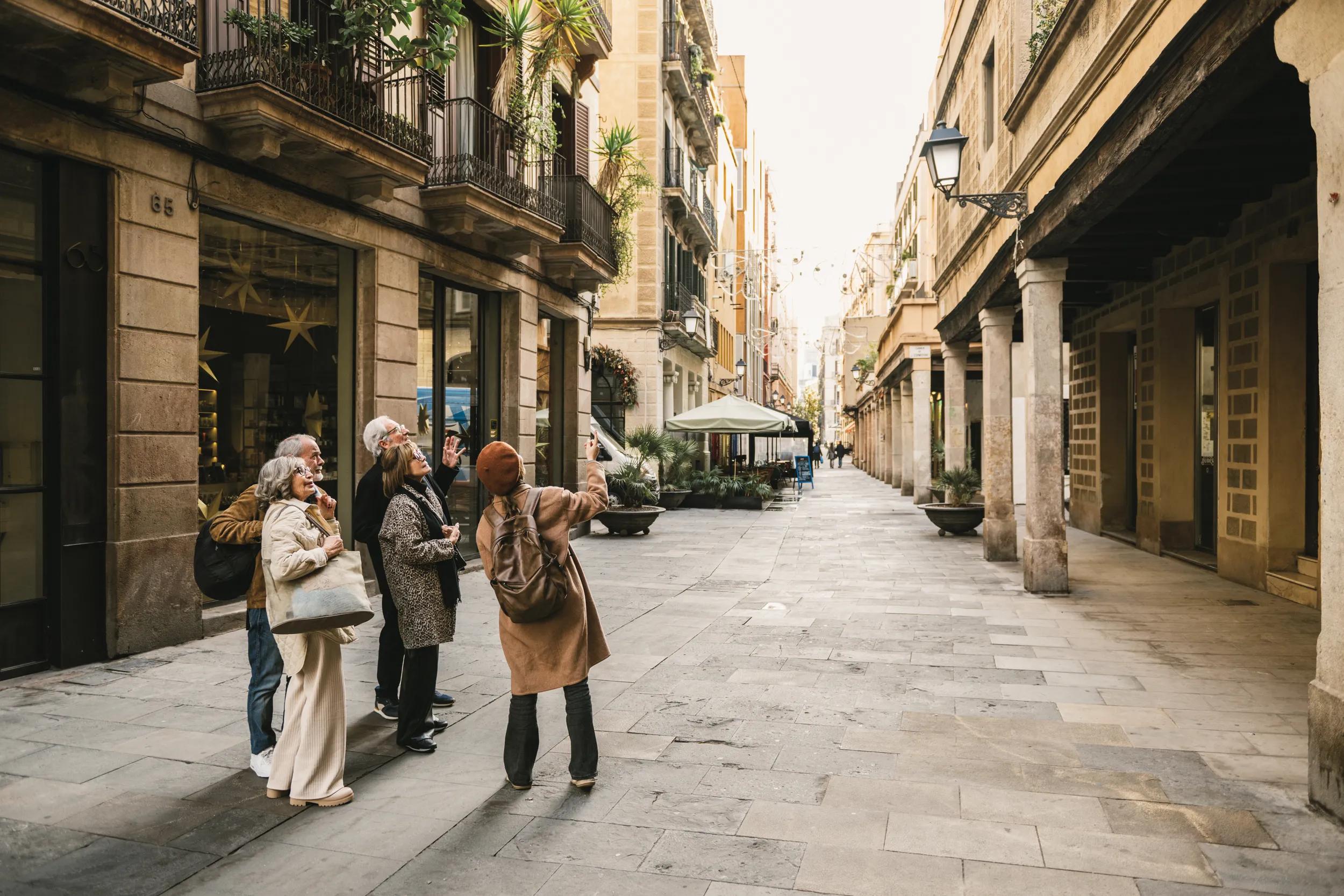 Tourist guide showing Barcelona Historic district to a group