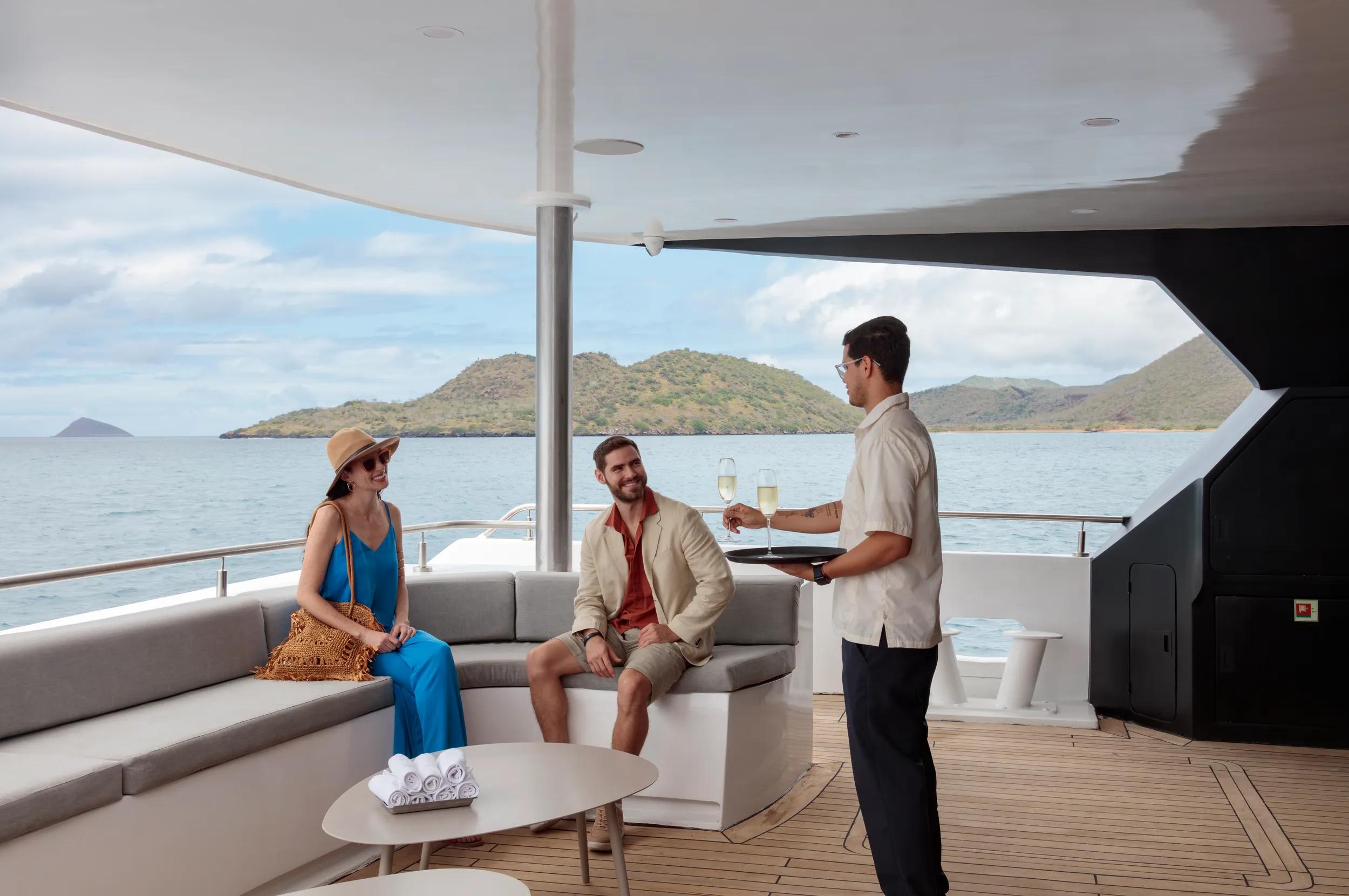 Hermes Galapagos Mega Catamaran couple on ship with host