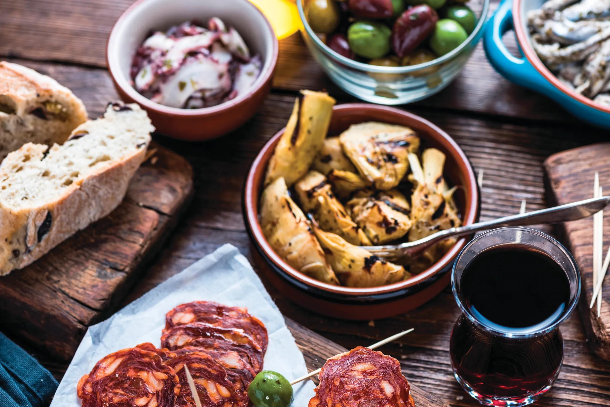 Sharing authentic spanish tapas with friends in restaurant or bar. View from above.