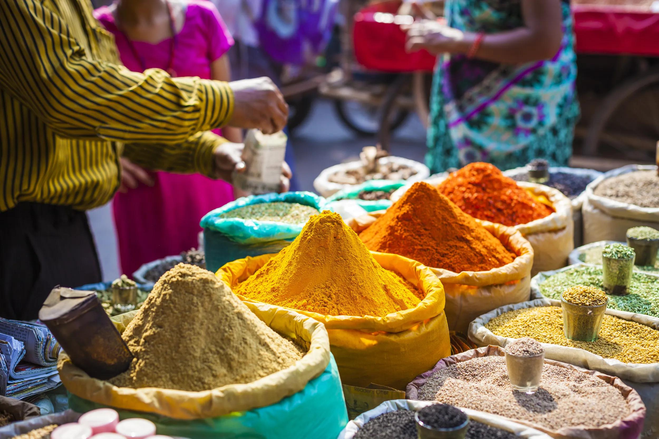Colorful spices powders and herbs in traditional street market in Delhi. India.
