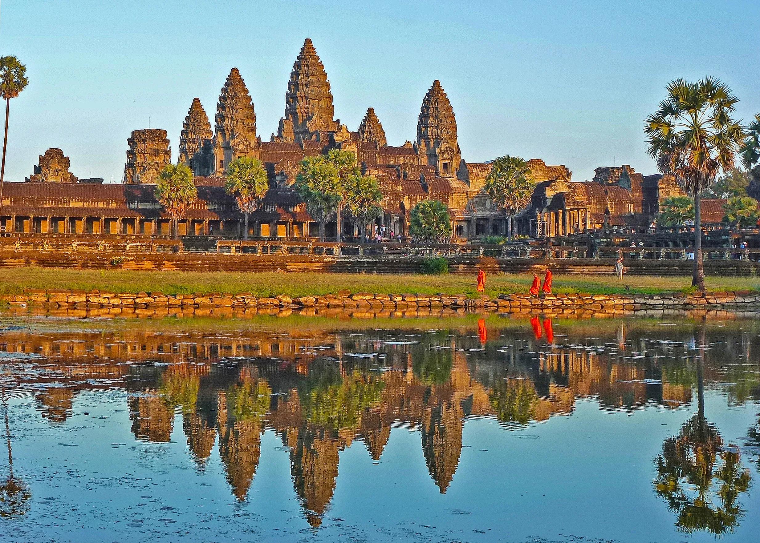 Angkor wat temple reflecting in lake.