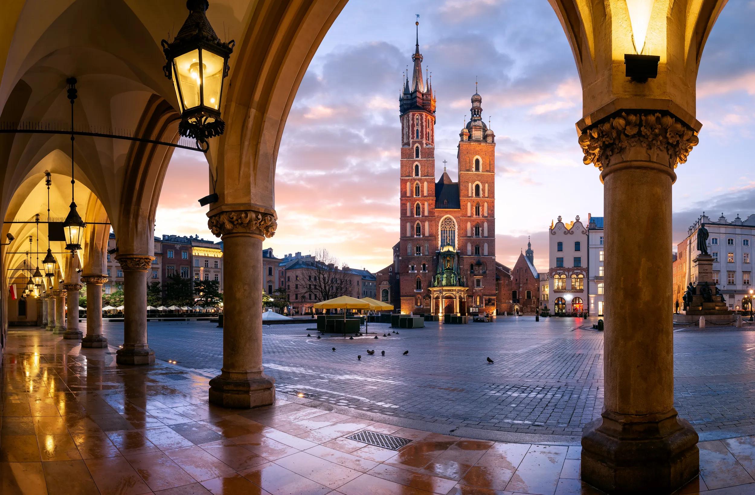 St Mary's Basilica, (Bazylika Mariacka) Church.Photograph taken at sunrise through the arches of the Cloth Hall, Krakow, Poland.