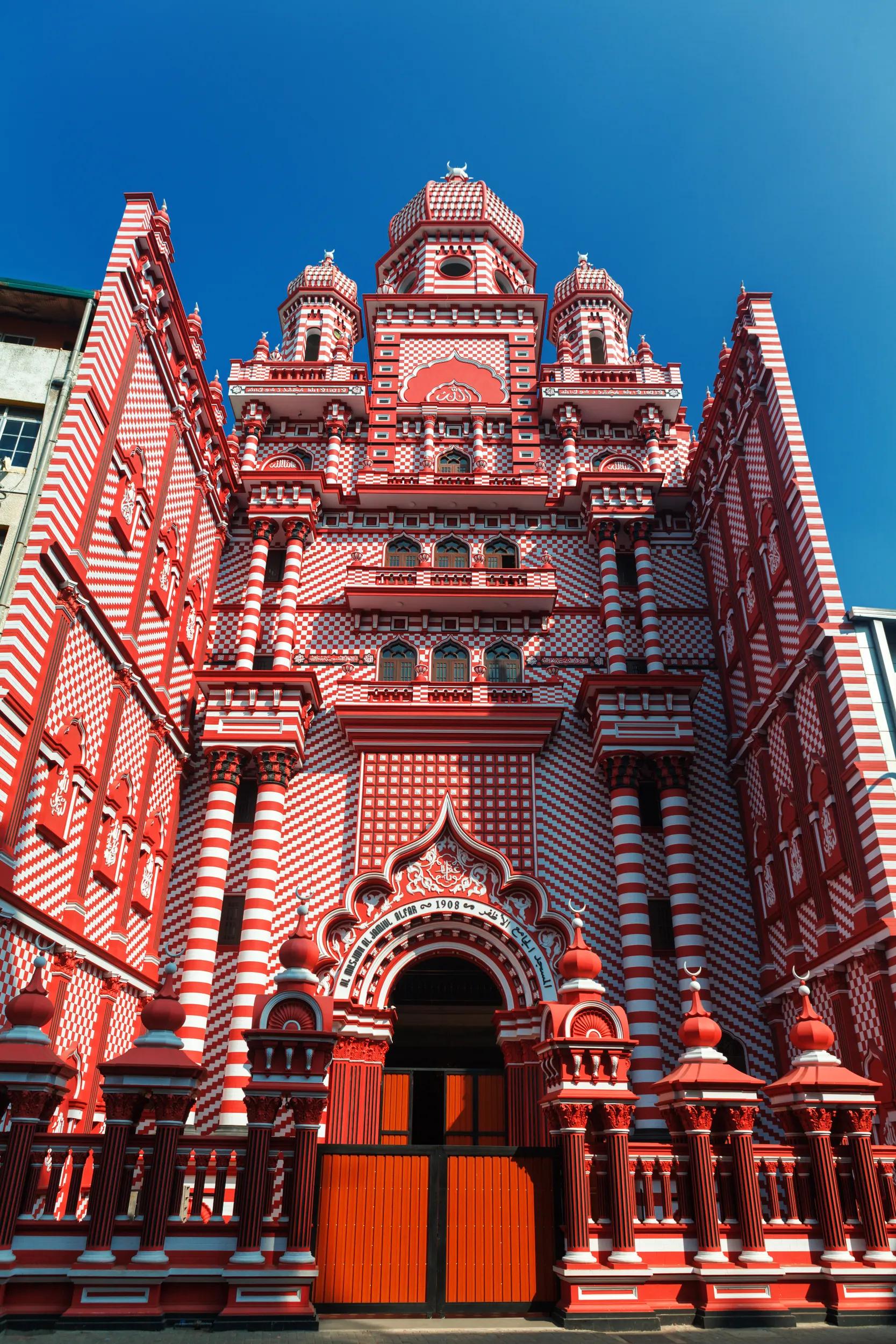 Colombo, Sri Lanka - 11 February, 2017: The decorative red-and-white facade of Jamiul Alfar Mosque, built in 1908, in the heart of the bazaar of Pettah, one of the oldest districts in Colombo.